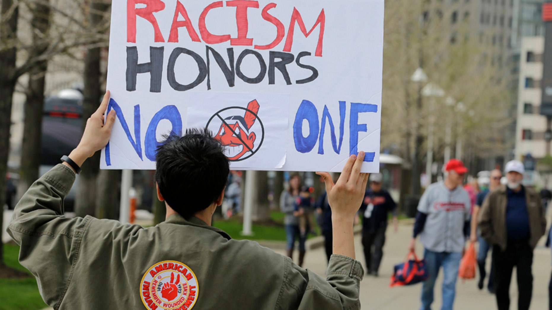 April 11, 2017: Josh Hunt protests as fans walk to the ballpark before a baseball game between the Chicago White Sox and the Cleveland Indians during opening day in Cleveland. Hunt is from the Cheyenne and Arapaho Tribe.