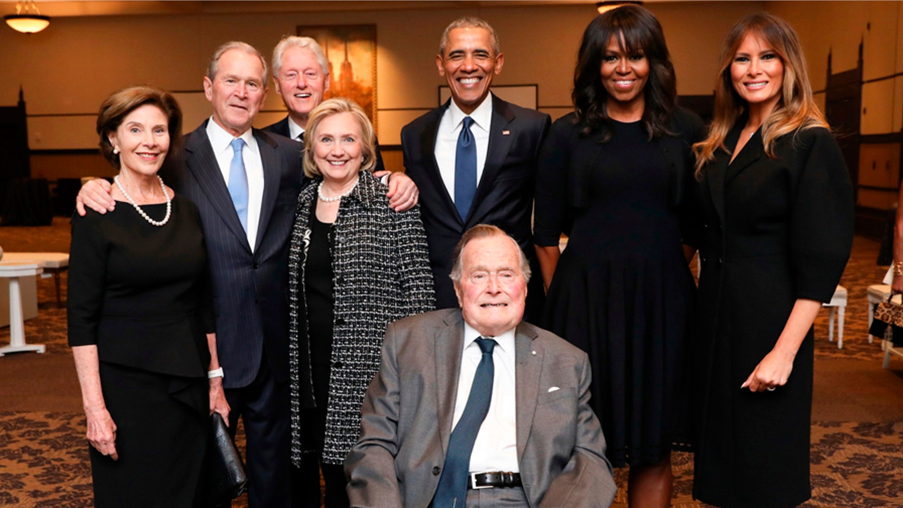 Former President George H. W. Bush, center, with First Ladies Melania Trump, far right, Michelle Obama, right, Former President Barack Obama, upper center, former Secretary of State Hillary Clinton, left, former Presidents Bill Clinton and George W. Bush, and former First Lady Laura Bush pose for a photo at the funeral of former First Lady Barbara Bush.