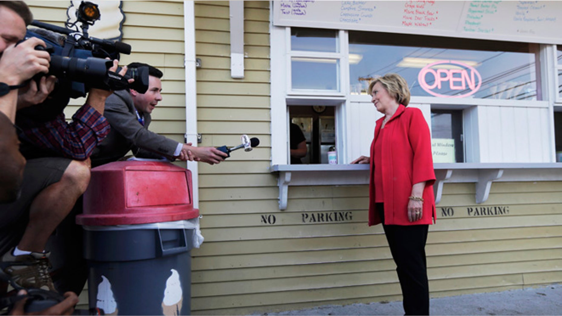 July 3, 2015: Democratic presidential candidate Hillary Rodham Clinton listens to a reporter's question as she waits for her ice cream at Dairy Twirl in New Hampshire.