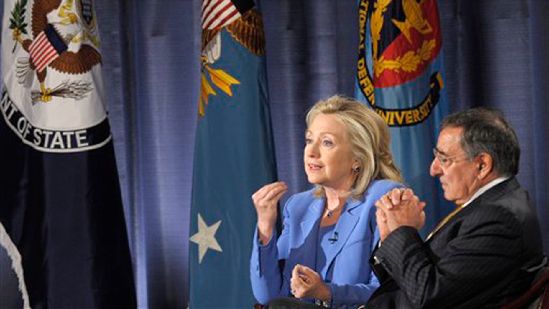 Secretary of State Hillary Clinton, accompanied by Defense Secretary Leon Panetta, speaks during an event at the National Defense University in Washington, D.C., Aug. 16.