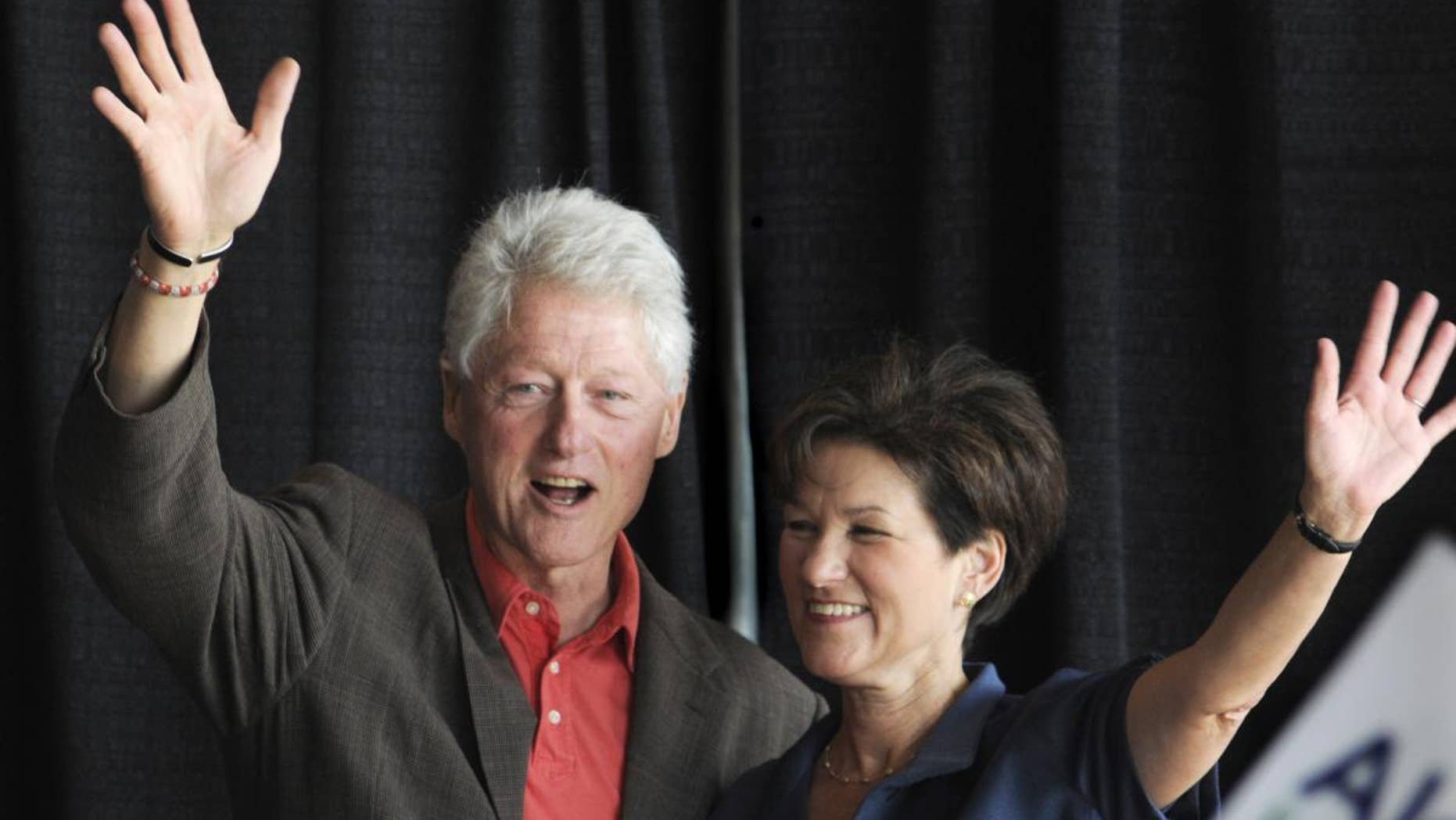 Former President Bill Clinton, left, joins Democratic gubernatorial candidate Alex Sink for an early vote rally in Miami at Miami Dade College North Campus, Thursday, Oct. 21, 2010. President Clinton addressed how critical voting for Sink is, especially during an election year that will so greatly impact the future of Florida. (AP Photo/The Miami Herald, Marice Cohn Band)