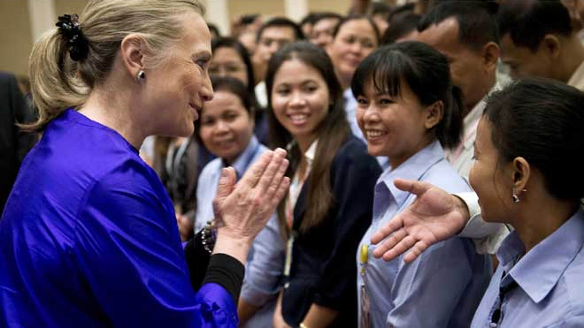 July 13, 2012: U.S. Secretary of State Hillary Rodham Clinton, left, greets U.S. Embassy staff at the Le Royal hotel in Phnom Penh, Cambodia.