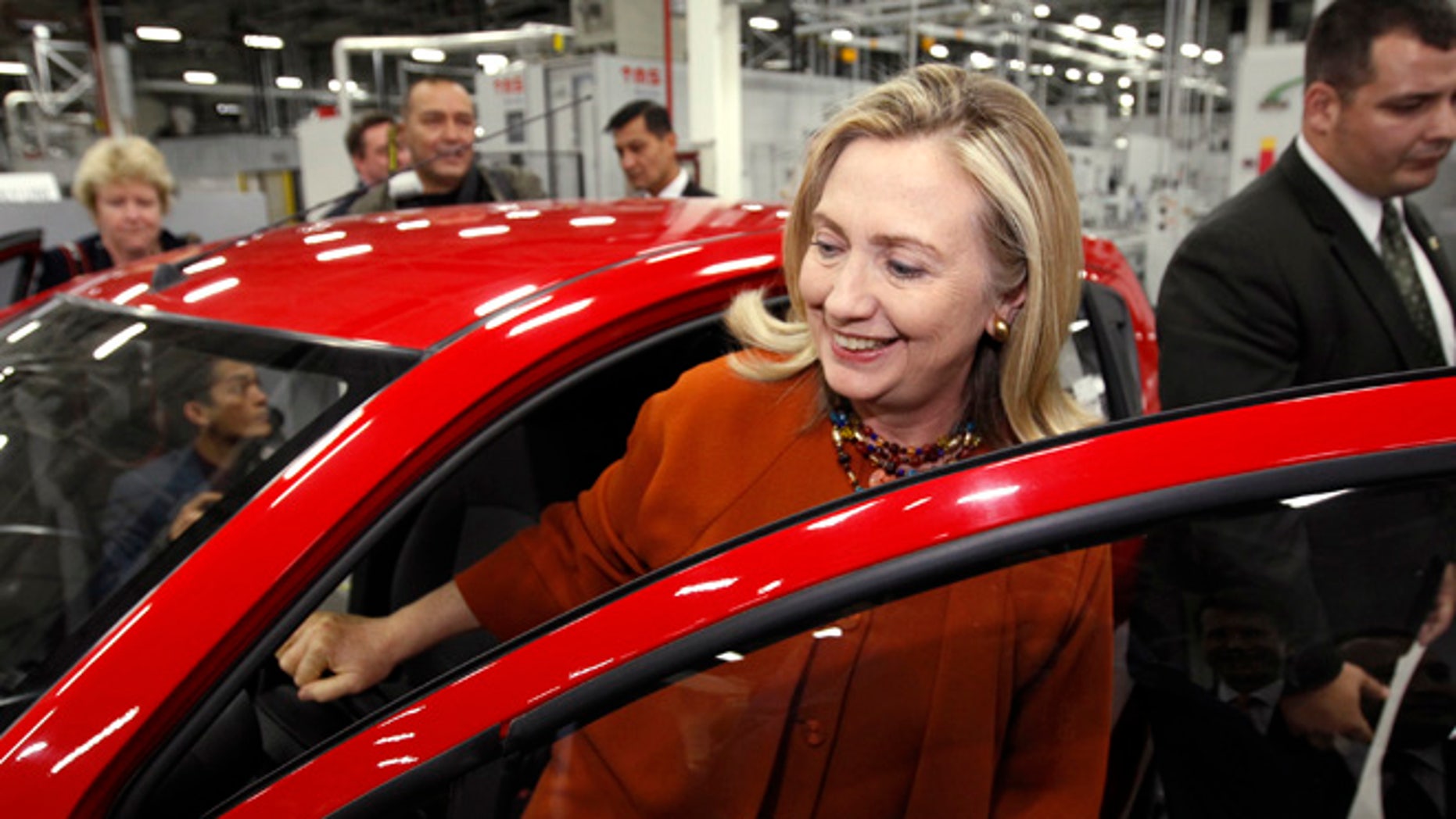 October 23, 2011: U.S. Secretary of State Hillary Clinton gets out of a GM "Spark" while touring the GM Powertrain plant in Tashkent, Uzbekistan.