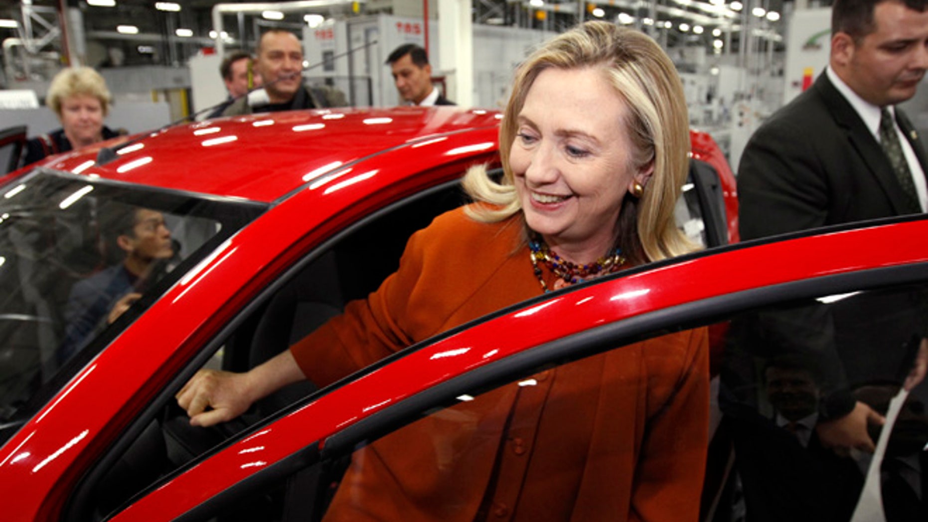 October 23, 2011: U.S. Secretary of State Hillary Clinton gets out of a GM "Spark" while touring the GM Powertrain plant in Tashkent, Uzbekistan.