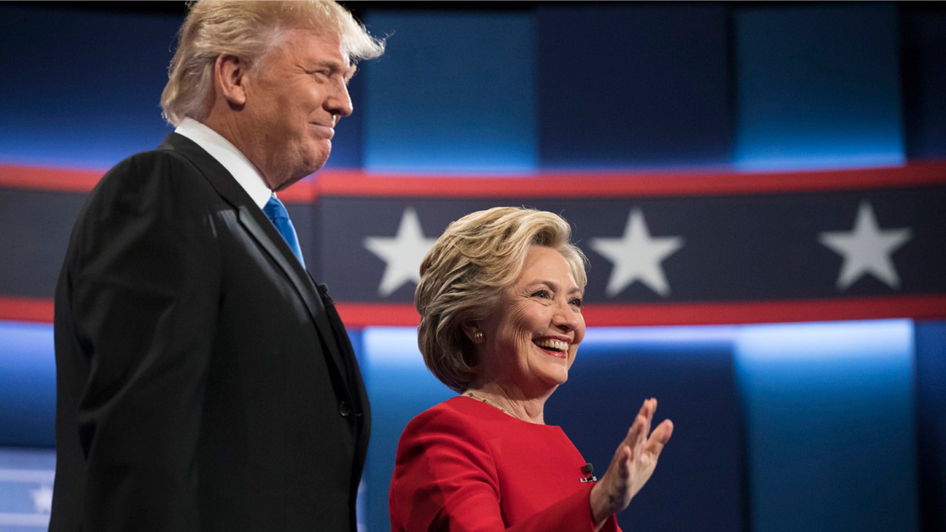 Democratic presidential nominee Hillary Clinton, right, stands with Republican presidential nominee Donald Trump at the start of the presidential debate at Hofstra University in Hempstead, N.Y., (AP Photo/Matt Rourke)
