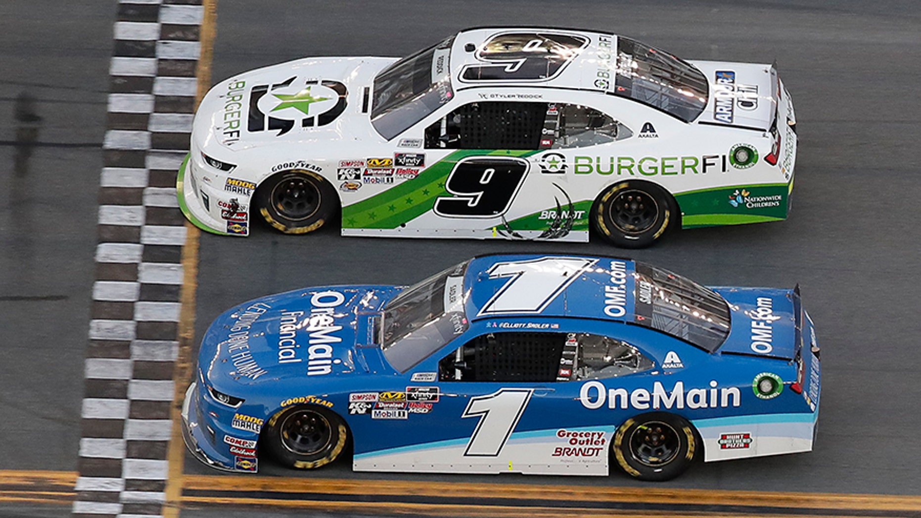 Tyler Reddick (9) beats teammate Elliott Sadler (1) at the NASCAR Xfinity Series race at Daytona International Speedway.