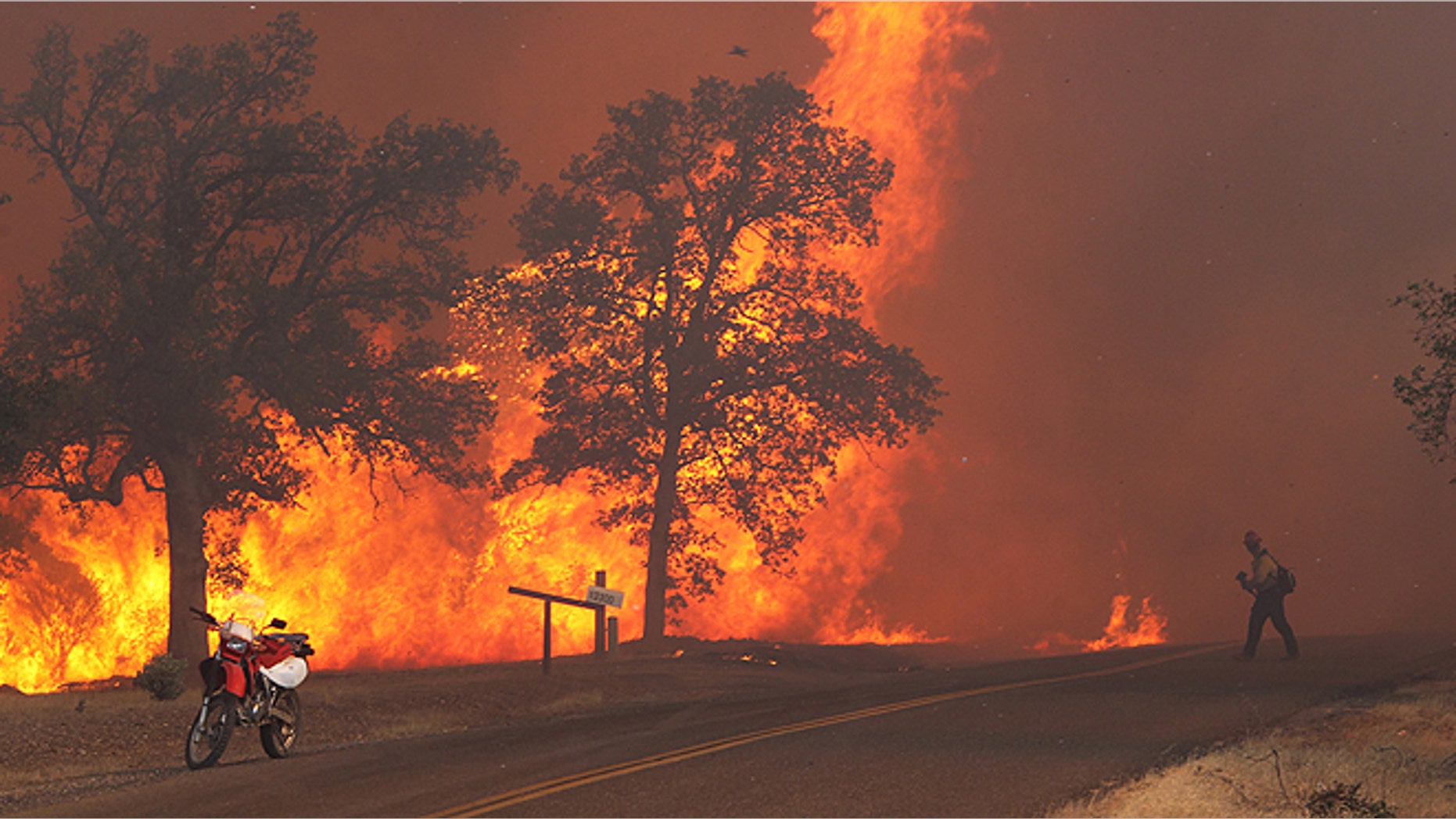 Sept. 9, 2013: A firefighter works the Clover Fire in Anderson, Calif., on Gas Point Road. The fire destroyed at least 20 buildings and burned more than 6,700 acres by Monday night. (AP/The Record Searchlight, Andreas Fuhrmann)