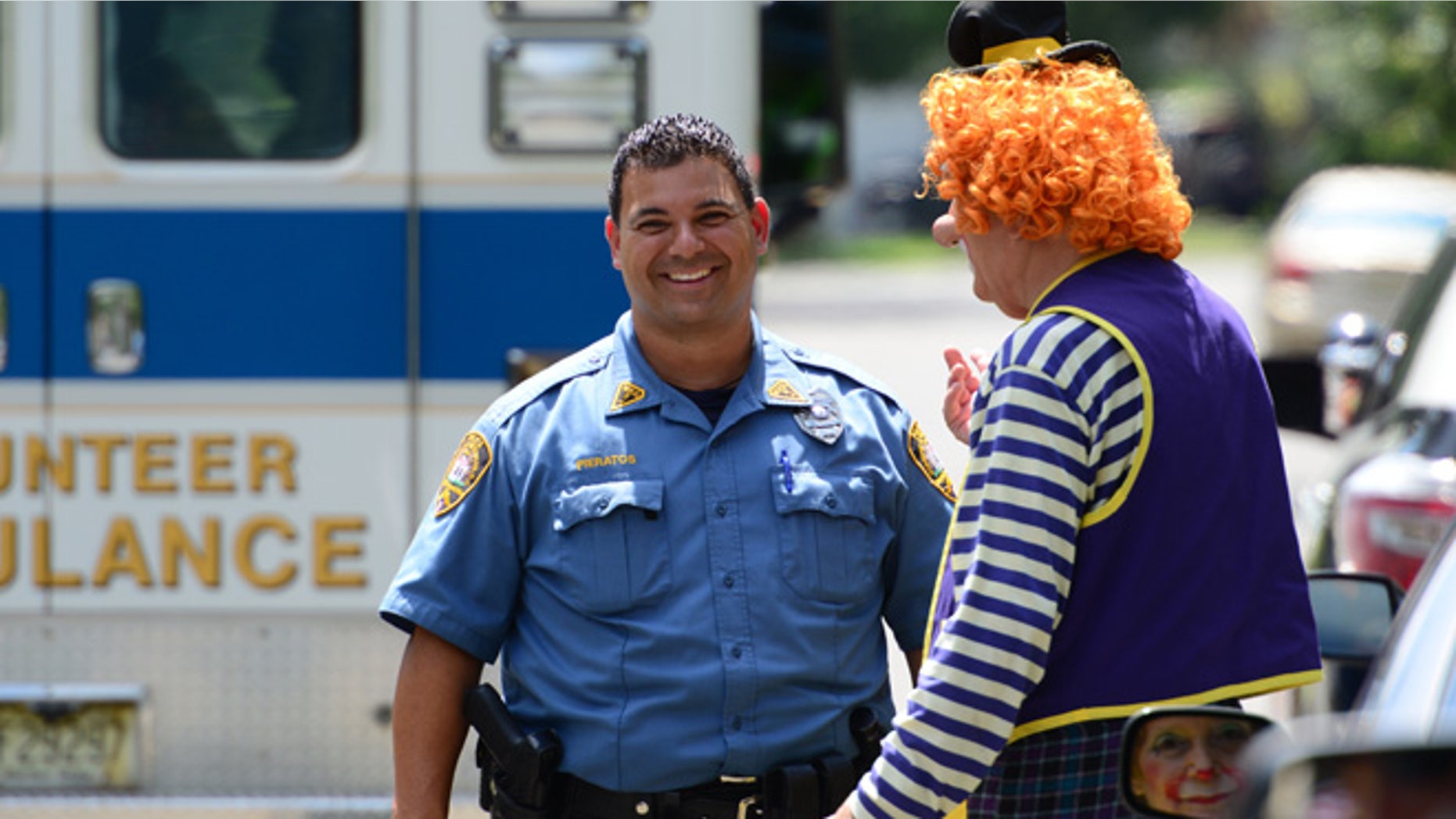 July 29, 2014: Westwood Police Officer Niko Pieratos talks speaks with Jack "Poppi T Clown" Erbstein in Westwood, N.J. following a minor traffic accident.