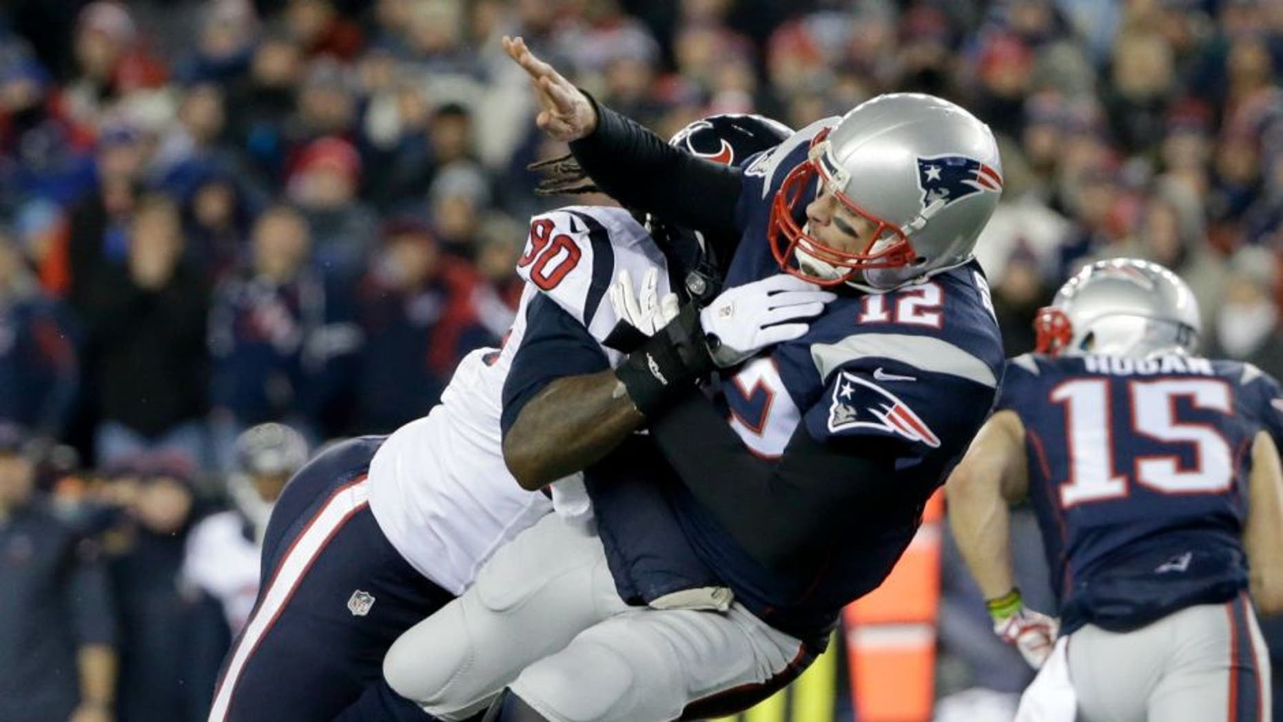 Houston Texans defensive end Jadeveon Clowney (90) levels New England Patriots quarterback Tom Brady (12) after he threw a pass during the first half of an NFL divisional playoff football game, Saturday, Jan. 14, 2017, in Foxborough, Mass. (AP Photo/Elise Amendola)
