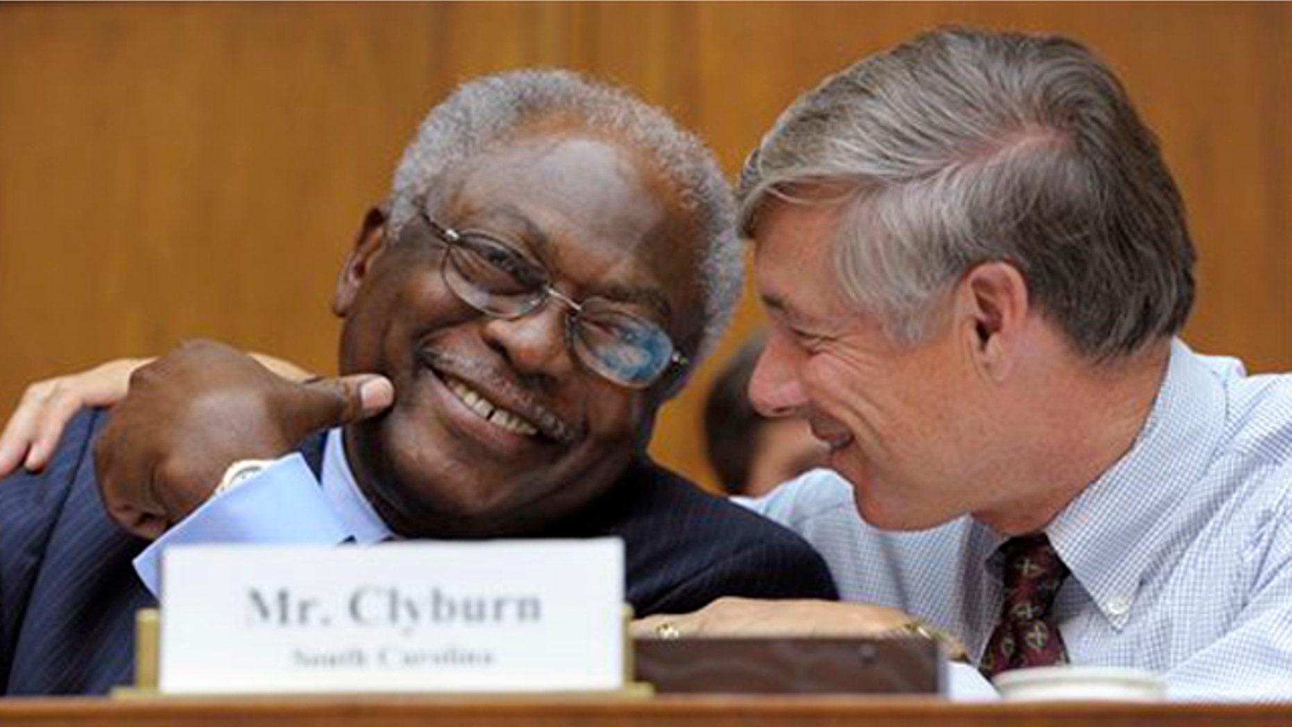 Rep. James Clyburn, left, shares a laugh with Rep. Fred Upton, right, before the start of the Joint Select Committee on Deficit Reduction meeting in Washington Sept. 8.