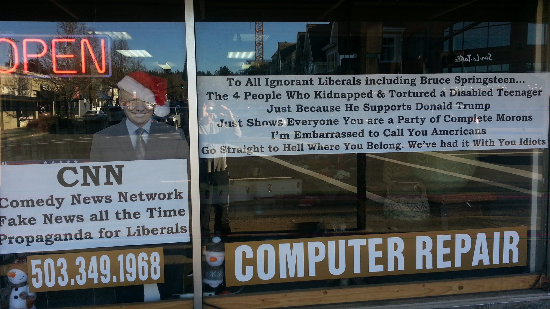 He put this giant sign in the window of his store in Lake Oswego, Oregon.