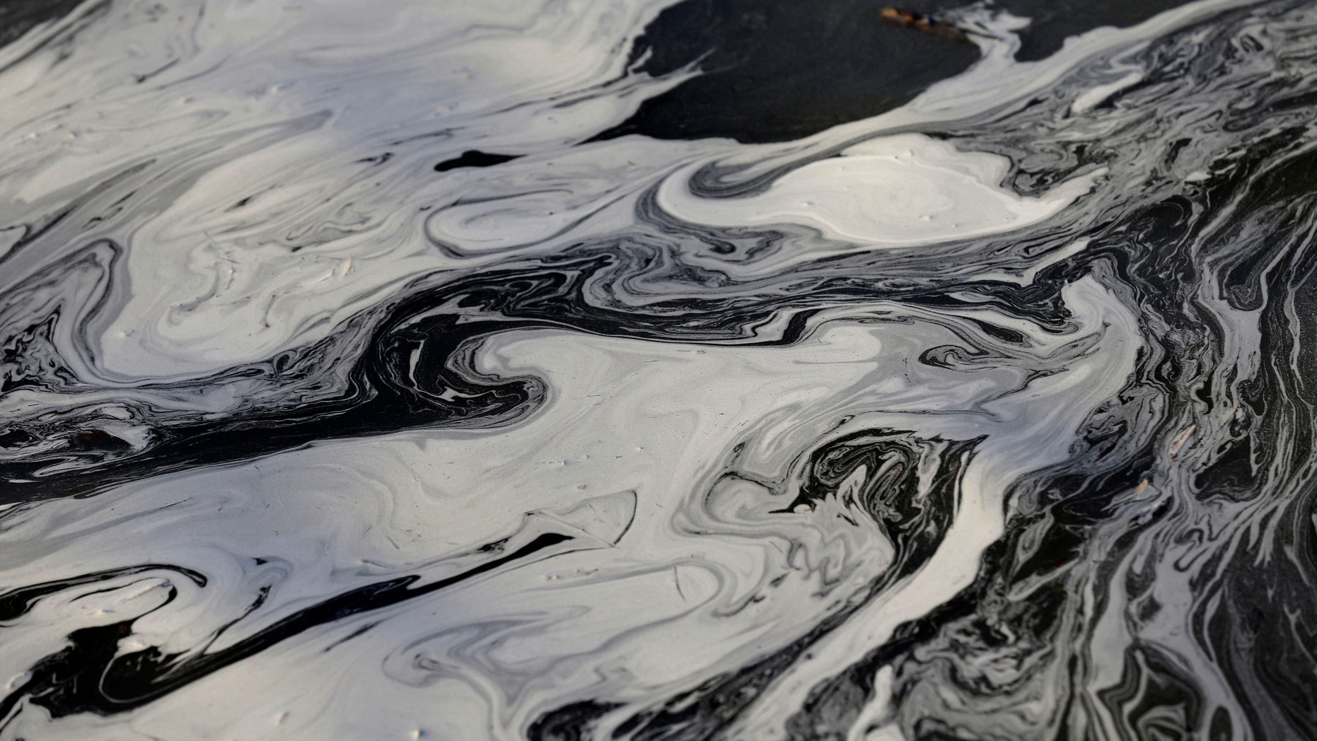 Feb. 5, 2014: coal ash swirls on the surface of the Dan River as state and federal environmental officials continued their investigations of a spill of coal ash into the river in Danville, Va.