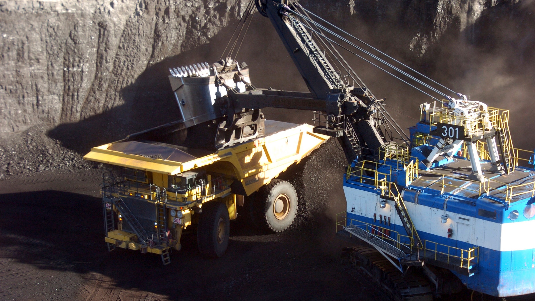 In this Nov. 15, 2016 photo, a mechanized shovel loads coal from an 80-feet thick seam into a haul truck at Cloud Peak Energy's Spring Creek mine near Decker, Mont. Coal from the mine is shipped to power plants for generating electricity. President-elect Donald Trump's vow to revive coal country is met with measured hope in Appalachia and even out West, where mines stand to gain the most. (AP Photo/Matthew Brown)
