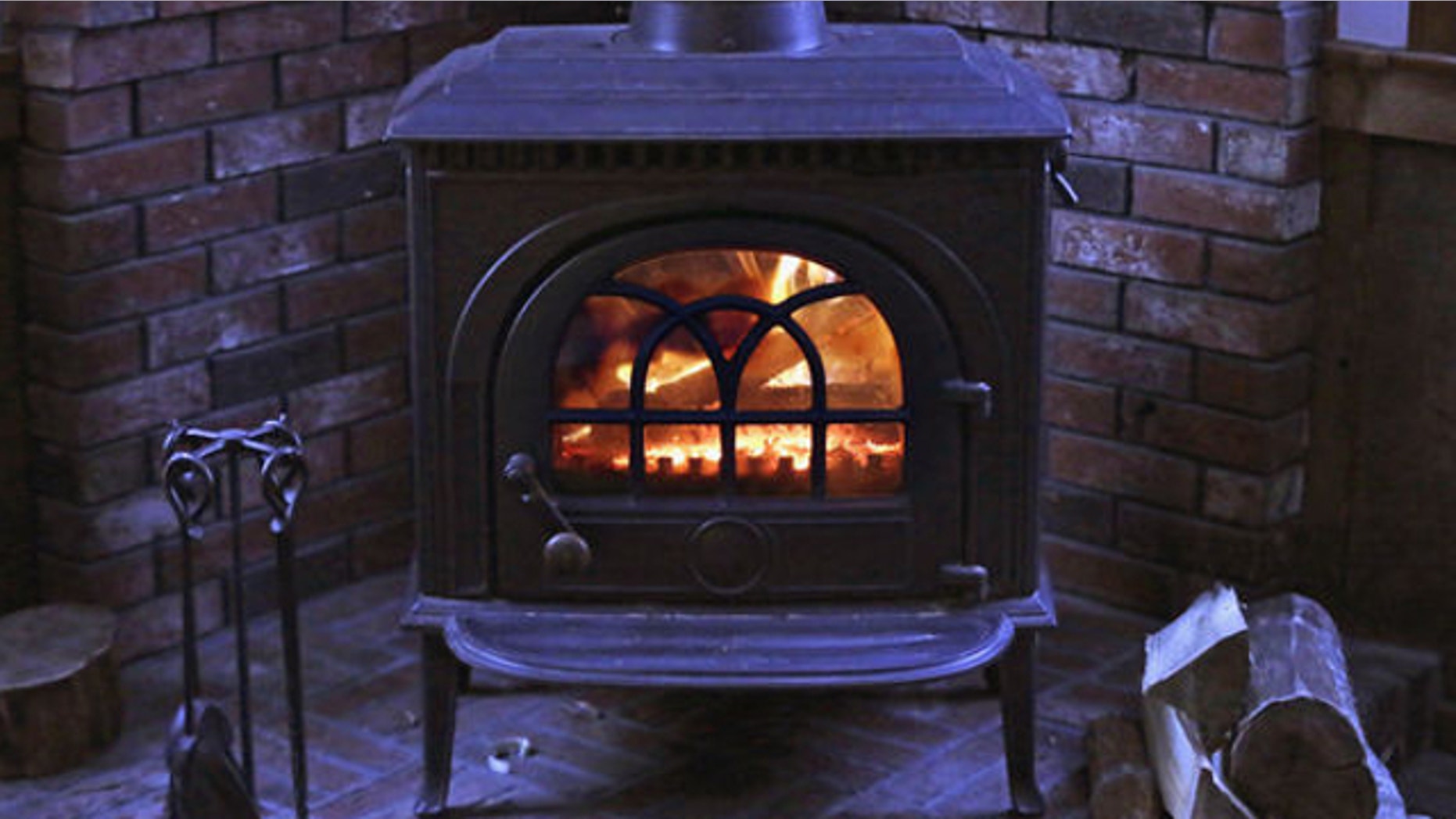 FILE: March 8, 2014: A wood stove heats a home in Freeport, Maine.