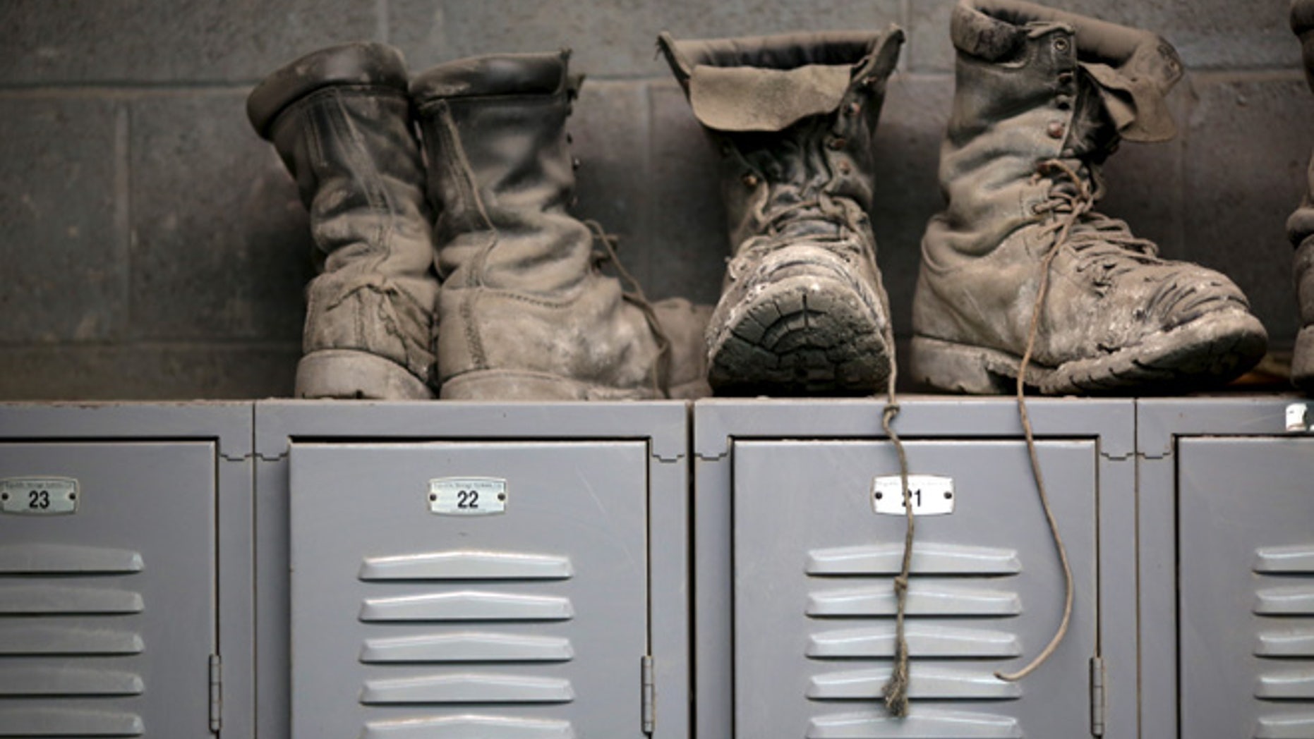 FILE 2014: Coal mining boots are shown above miners’ lockers before the start of an afternoon shift near Gilbert, West Virginia.