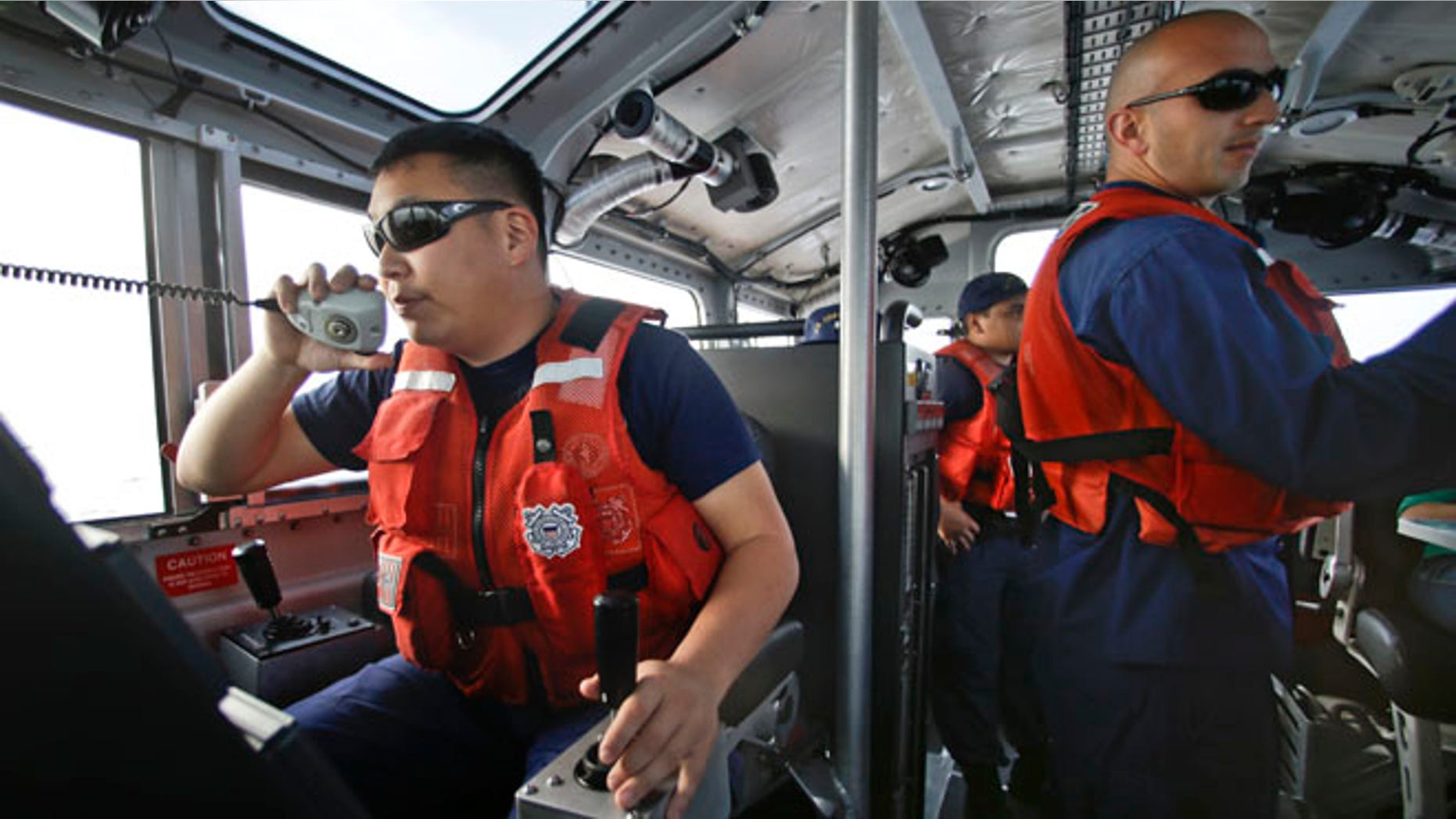 Jan. 28, 2014: Coast Guard officer William Pless communicates on the radio while steering the 45 foot Coast Guard vessel through a dense fog during a patrol off the San Diego coast in San Diego. With the drug war locking down land routes across Latin America and at the U.S. border, smugglers have been increasingly using large vessels to carry multi-ton loads of cocaine and marijuana hundreds of miles offshore, where the lead federal agency with extensive law enforcement powers is the Coast Guard, a military service roughly the size of the New York Police Department.