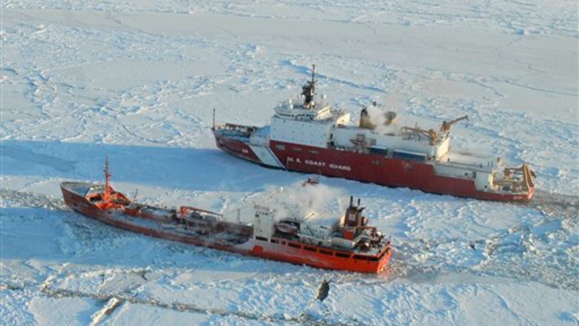 Jan. 6, 2012: The Coast Guard Cutter Healy breaks ice around the Russian-flagged tanker Renda 250 miles south of Nome. The Healy is the Coast Guard's only currently operating polar icebreaker. The vessels are transiting through ice up to five-feet thick in this area. The 370-foot tanker Renda will have to go through more than 300 miles of sea ice to get to Nome, a city of about 3,500 people on the western Alaska coastline that did not get its last pre-winter fuel delivery because of a massive storm.