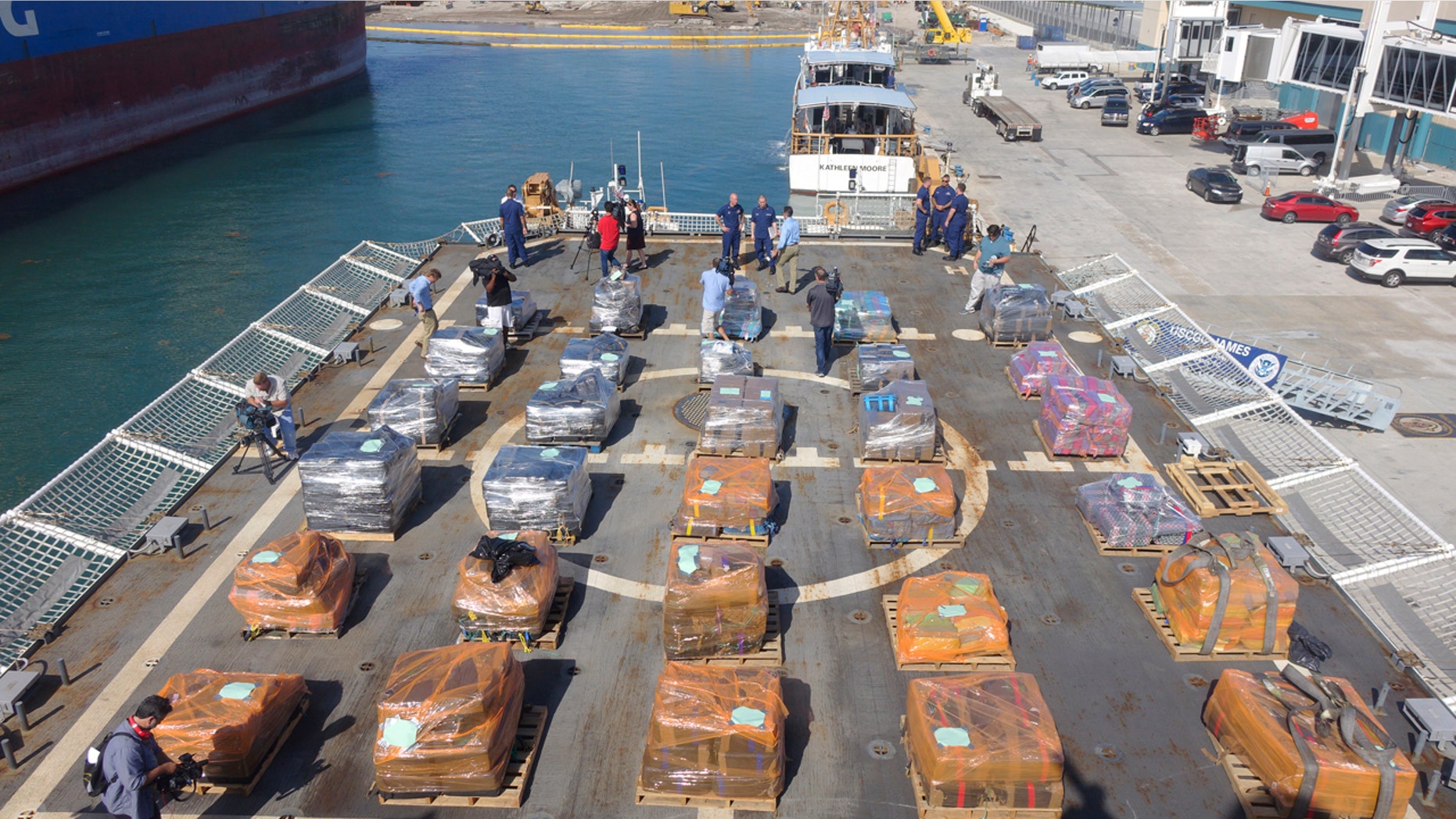 U.S. Customs and Border Patrol officers alongside Coast Guard personnel prepare to offload cocaine from the Coast Guard Cutter James, Tuesday, March 28, 2016, at Port Everglades in Fort Lauderdale, Fla.