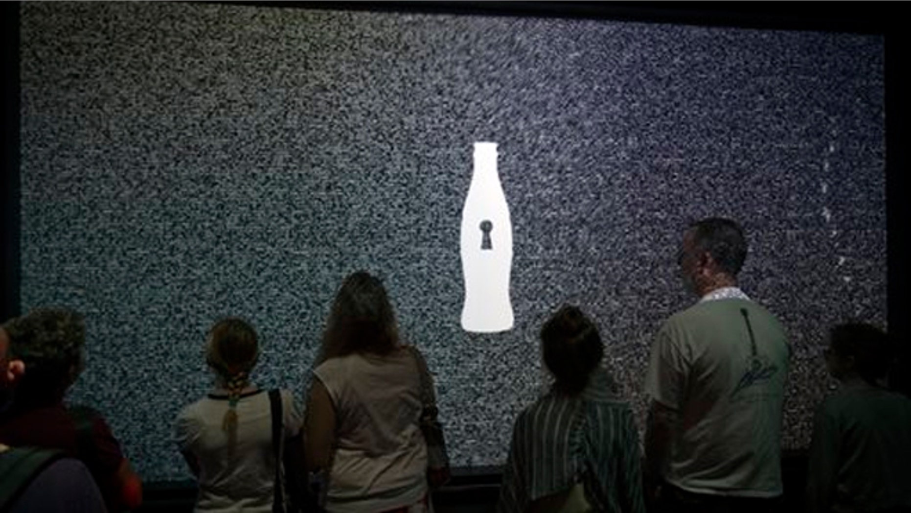 Aug. 9, 2013: A tour group waits for an interactive experience to begin before entering the vault chamber containing the “secret recipe” for Coca-Cola at the World of Coca-Cola museum, in Atlanta.