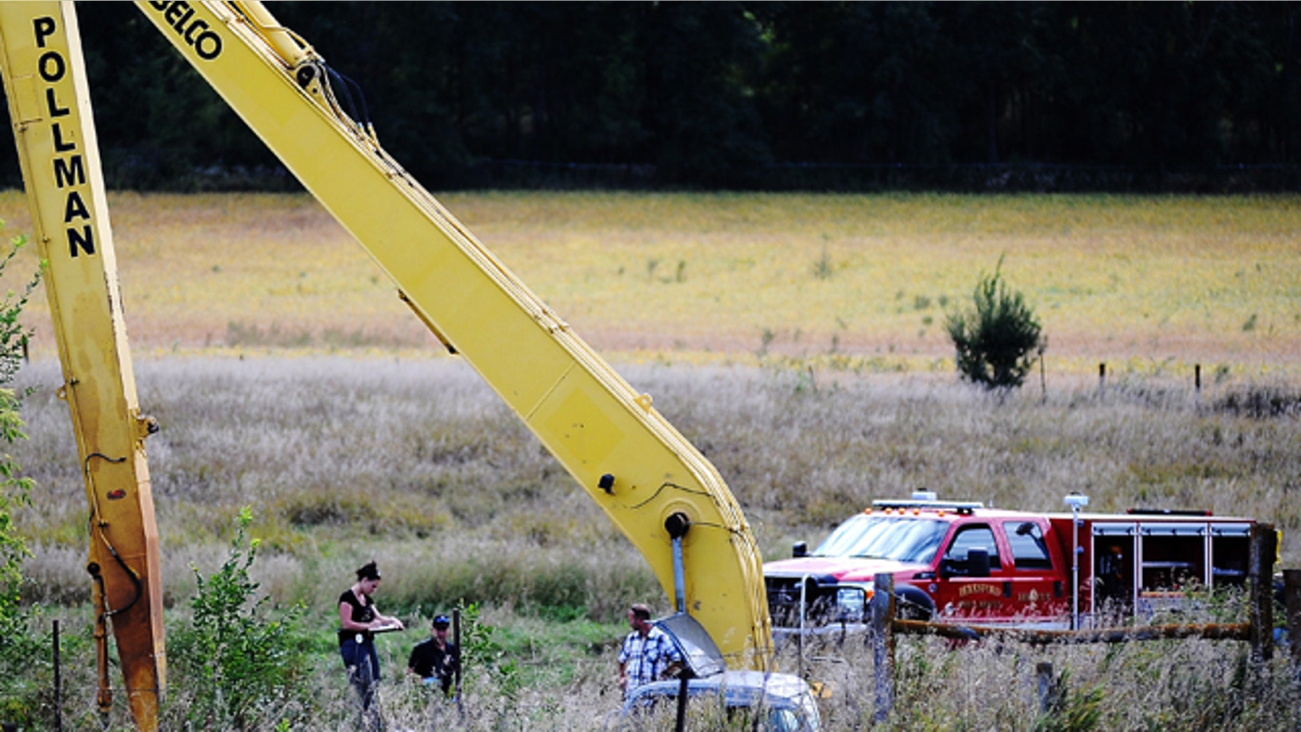 Sept. 23, 2013: Crews work to excavate a vehicle from an embankment near Beresford, S.D.