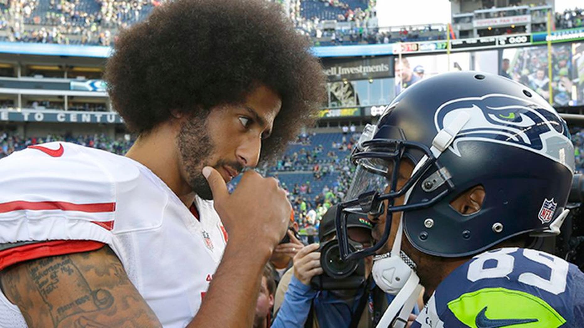 San Francisco 49ers quarterback Colin Kaepernick, left, talks with Seattle Seahawks wide receiver Doug Baldwin, right, following an NFL football game, Sunday, Sept. 25, 2016, in Seattle. The Seahawks defeated the 49ers 37-18. (AP Photo/Ted S. Warren)