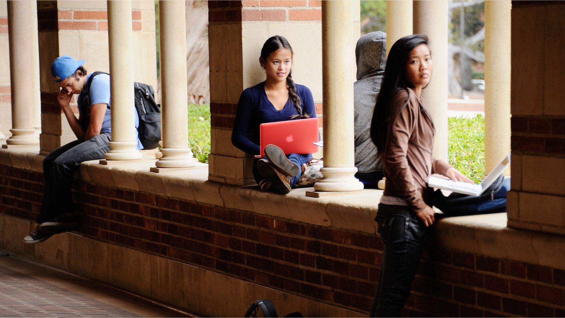 LOS ANGELES, CA - APRIL 23: Students take a break at Royce Hall on the campus of UCLA on April 23, 2012 in Los Angeles, California. According to reports, half of recent college graduates with bachelor's degrees are finding themselves underemployed or jobless. (Photo by Kevork Djansezian/Getty Images)
