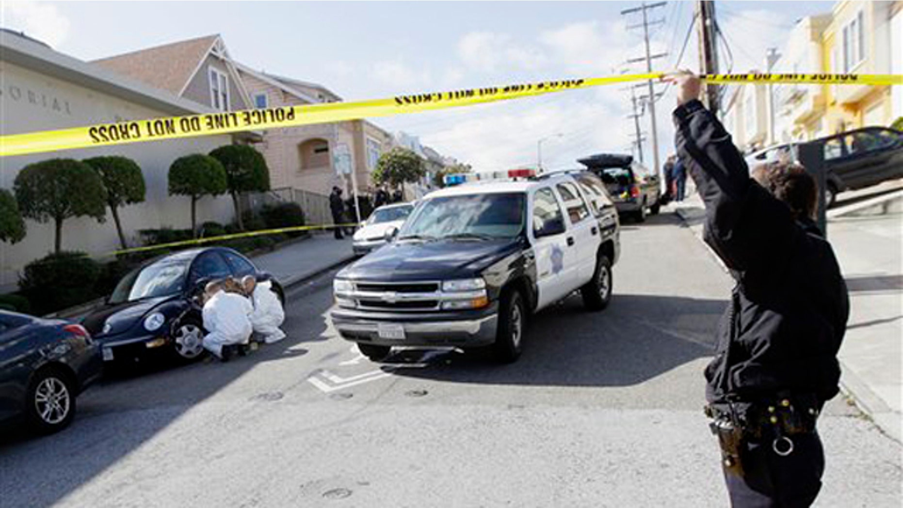 March 23, 2012: San Francisco Police officers inspect outside of a home on Howth Street in San Francisco.