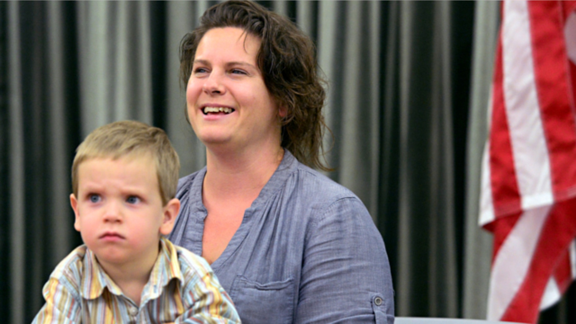 May 28, 2013: Brandy Turner, right, with her three-year-old son, Luke Turner, speaks to media during a news conference at the Denver International Airport.