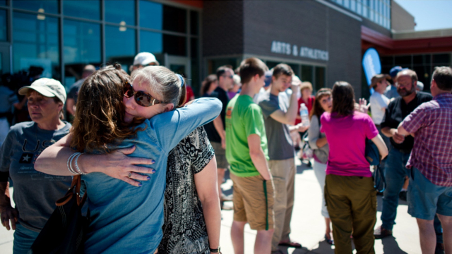 June 15, 2013: Black Forest residents hug outside a community meeting to give information regarding the Black Forest wildfire near Colorado Springs, Colo.