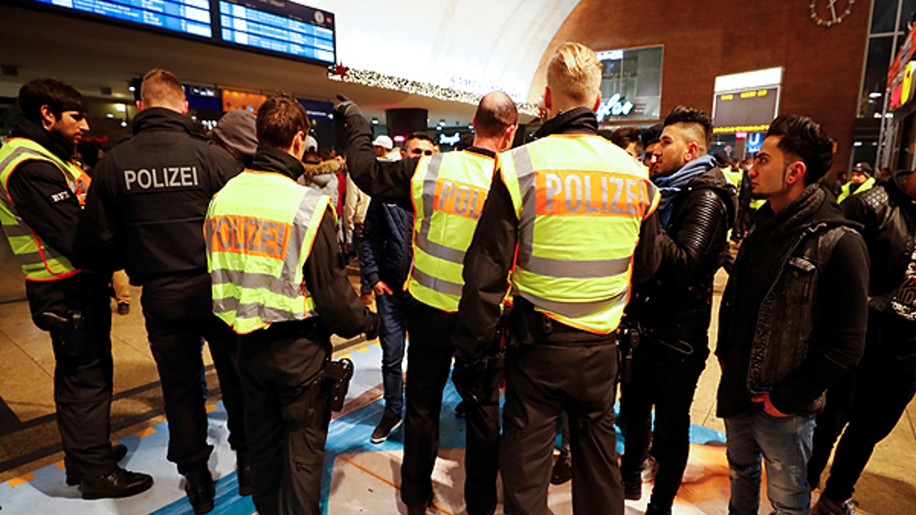 January 1, 2017: Police officers of Germany's federal police Bundespolizei check young men at the main railways station following New Year celebrations in Cologne, Germany.