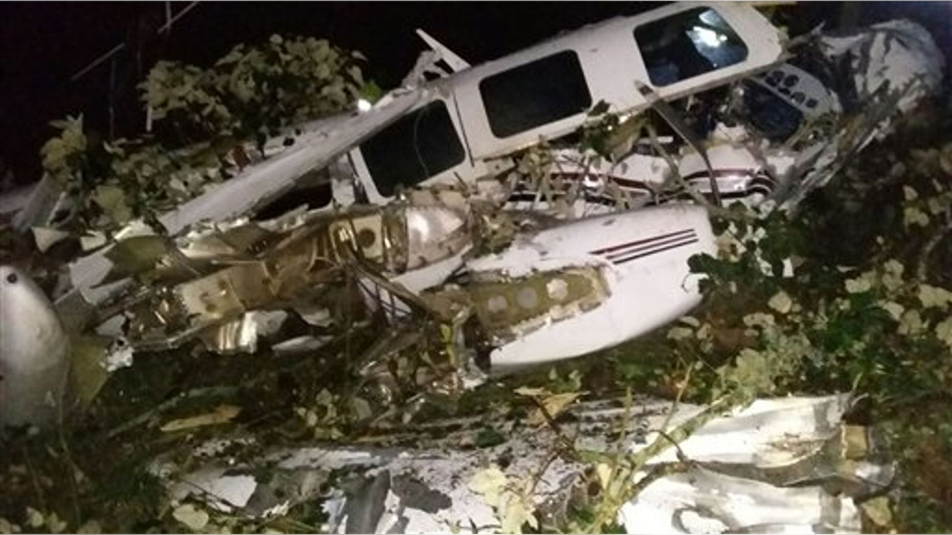 This photo released by the San Predro de los Milagros Fire Department shows the wreckage of a small plane assigned to the crew of a film starring Tom Cruise, that crashed, in a rural place of San Pedro de los Milagros, Colombia, Friday, Sept. 11, 2015. The country's civilian aviation authority said the twin-engine Aerostar crashed Friday after taking off from a small colonial town near Medellin, killing two people, including a Los Angeles-based film pilot, and seriously injuring a third. (San Pedro de los Milagros Fire Department via AP)