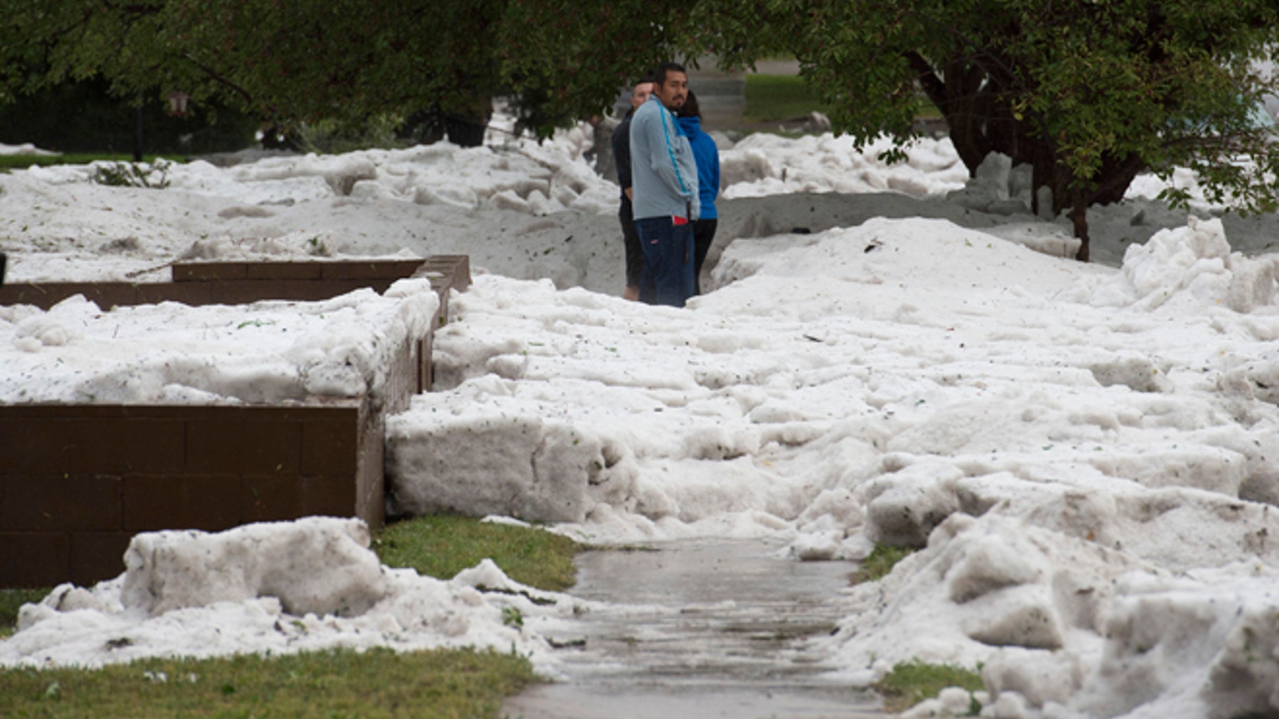 Hail as deep as two feet lies in the front yards of home along Logan Avenue between Platte Avenue and Bijou Street after a storm hit Colorado Springs, Colo., Monday, Aug. 29, 2016.