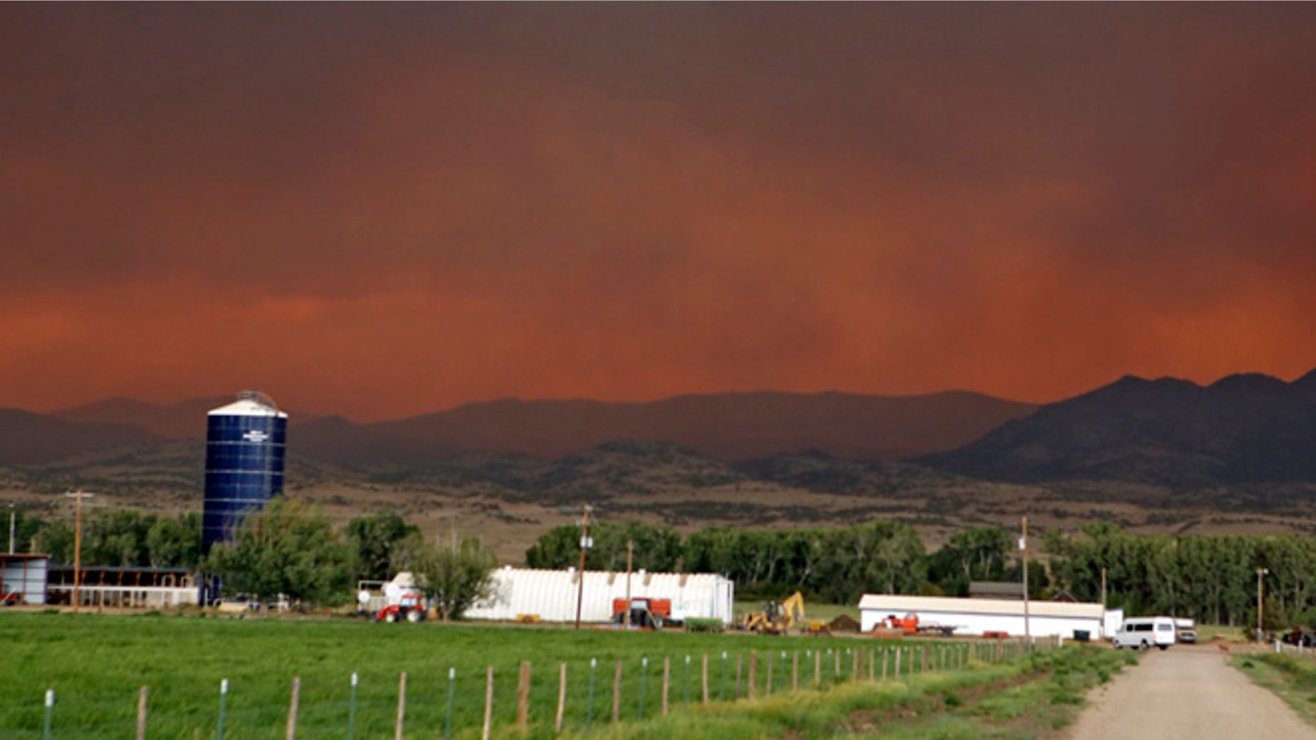 June 21, 2013: The smoke in the sky over a ranch near South Fork, Colo., glows red from a wildfire that is threatening the town. South Fork was evacuated Friday as the fire approaches from the west.