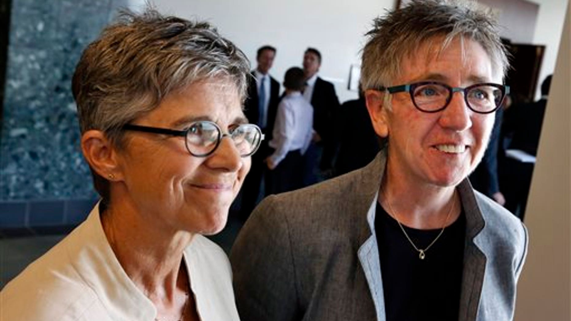 June 16, 2014: Plaintiffs in a gay-marriage case and longtime couple Rebecca Brinkman, left, and Margaret Burd take questions from members of the media following a hearing at Adams County District Court, in Brighton, Colo.