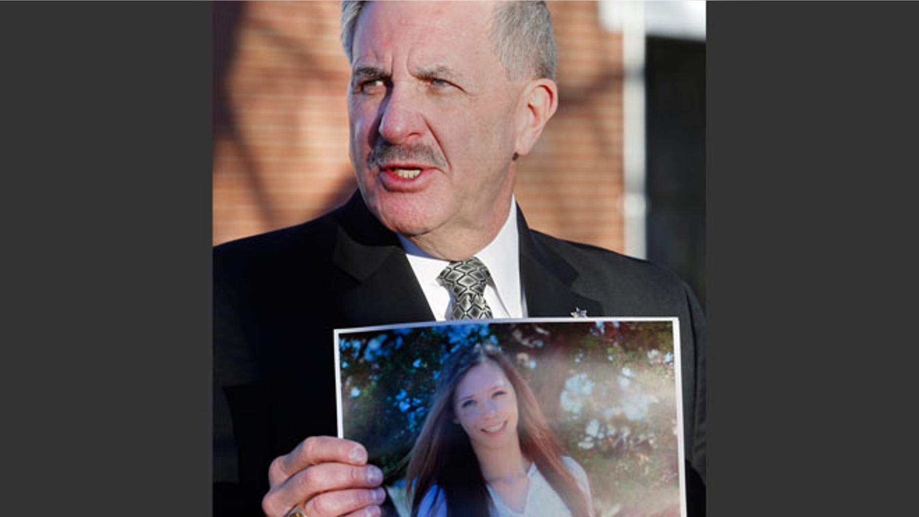 Dec. 14, 2013: Arapahoe County Sheriff Grayson Robinson holds a picture of Claire Davis, the 17-year-old student who was shot in the head by a classmate, during a briefing at Arapahoe High School in Centennial, Colo.