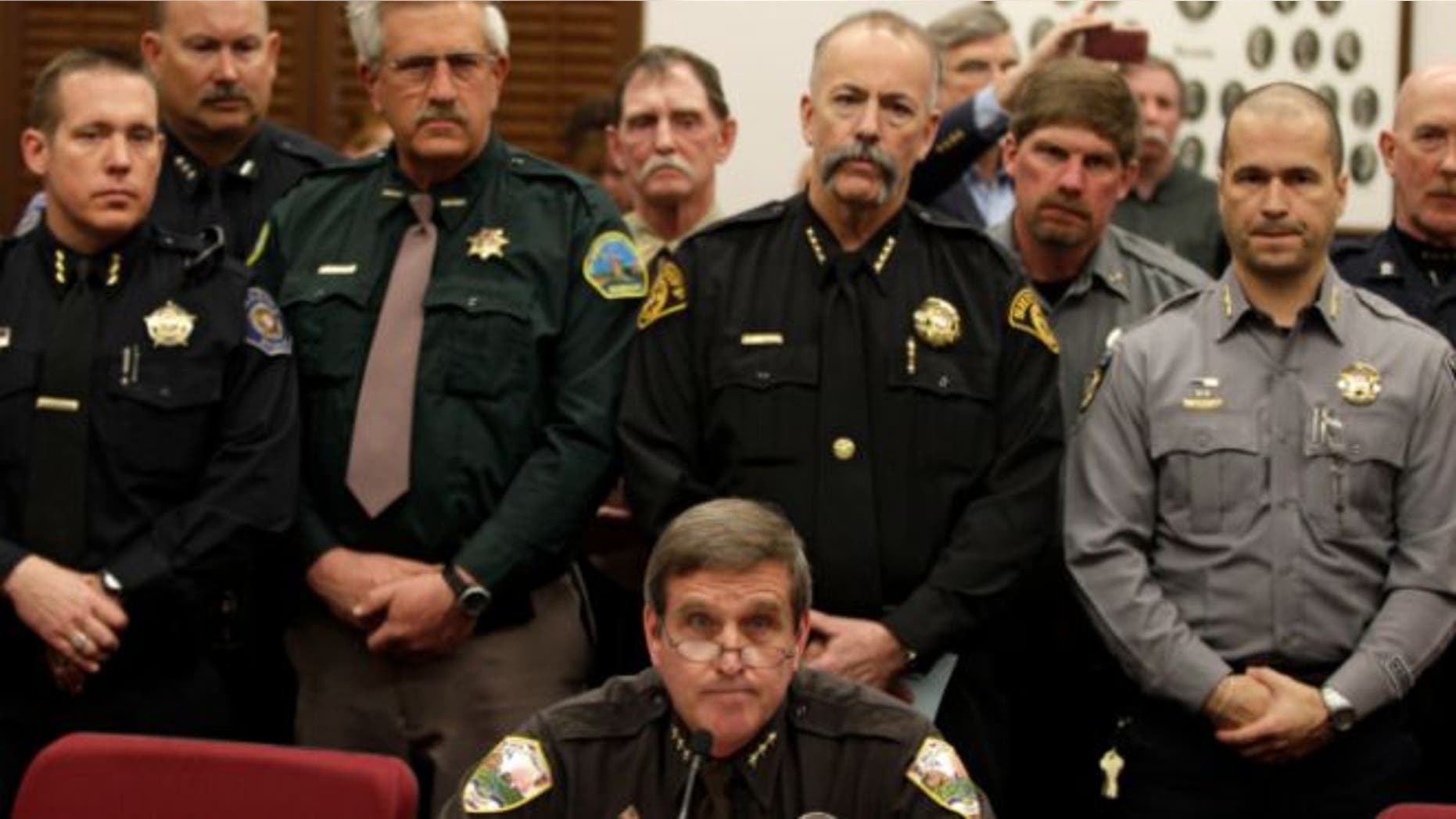 March 4, 2013: Weld County Sheriff John Cooke, center, backed by a group of fellow sheriffs, testifies against proposed gun control legislation in the Colorado Legislature, at the State Capitol, in Denver.