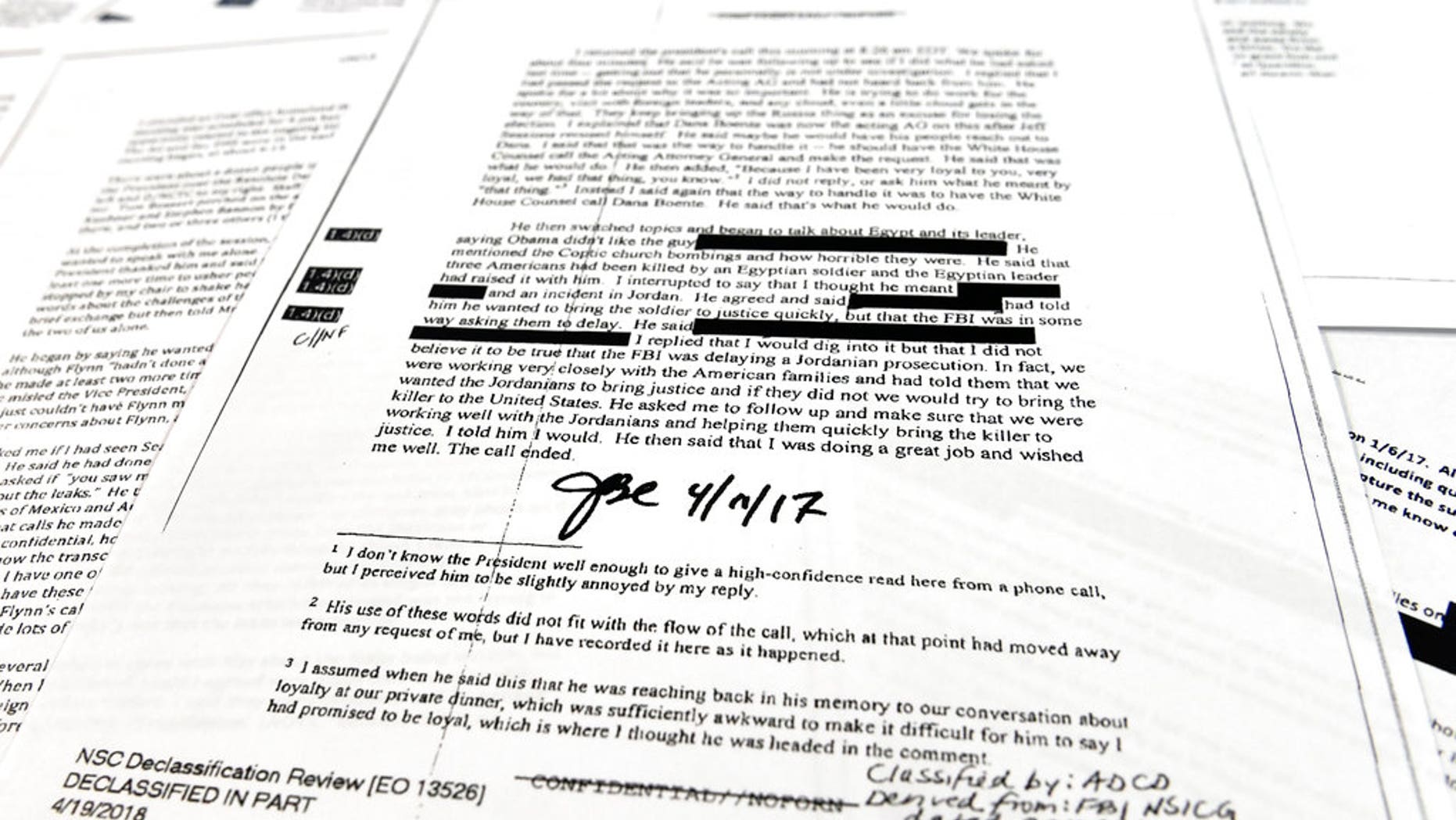 Copies of the memos written by former FBI Director James Comey are photographed in Washington, Thursday, April 19, 2018. President Donald Trump told former FBI Director James Comey that he had serious concerns about the judgment of his first national security adviser, Michael Flynn, according to memos maintained by Comey and obtained by The Associated Press. The 15 pages of documents contain new details about a series of interactions that Comey had with Trump in the weeks before his May 2017 firing. Those encounters include a White House dinner at which Comey says Trump asked him for his loyalty. (AP Photo/Susan Walsh)