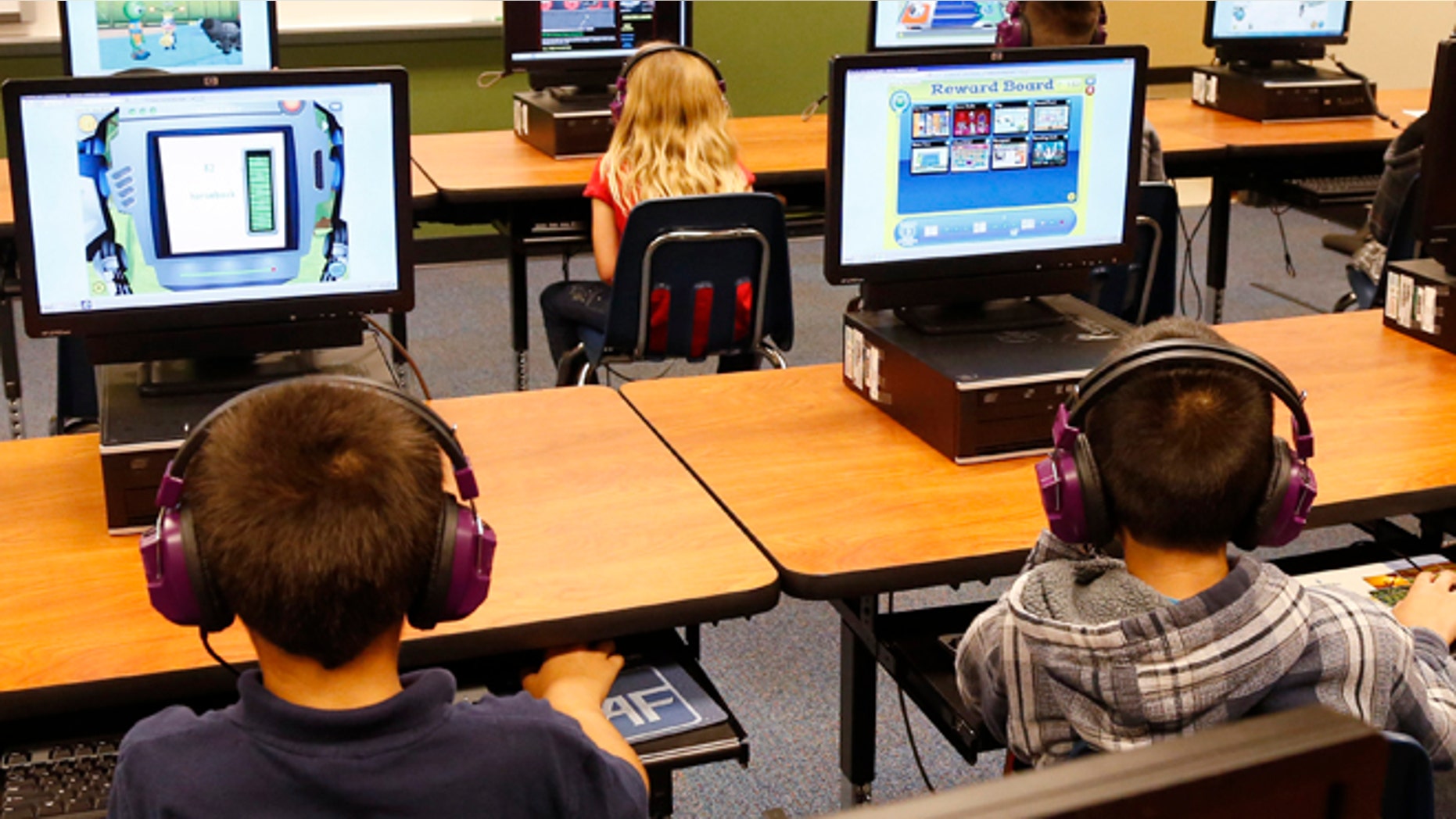 July 21, 2014: Students at a summer reading academy at Buchanan elementary school work in the computer lab at the school in Oklahoma City. Results for some of the states that participated in Common Core-aligned testing for the first time this spring are out, with overall scores higher than expected though still below what many parents may be accustomed to seeing.