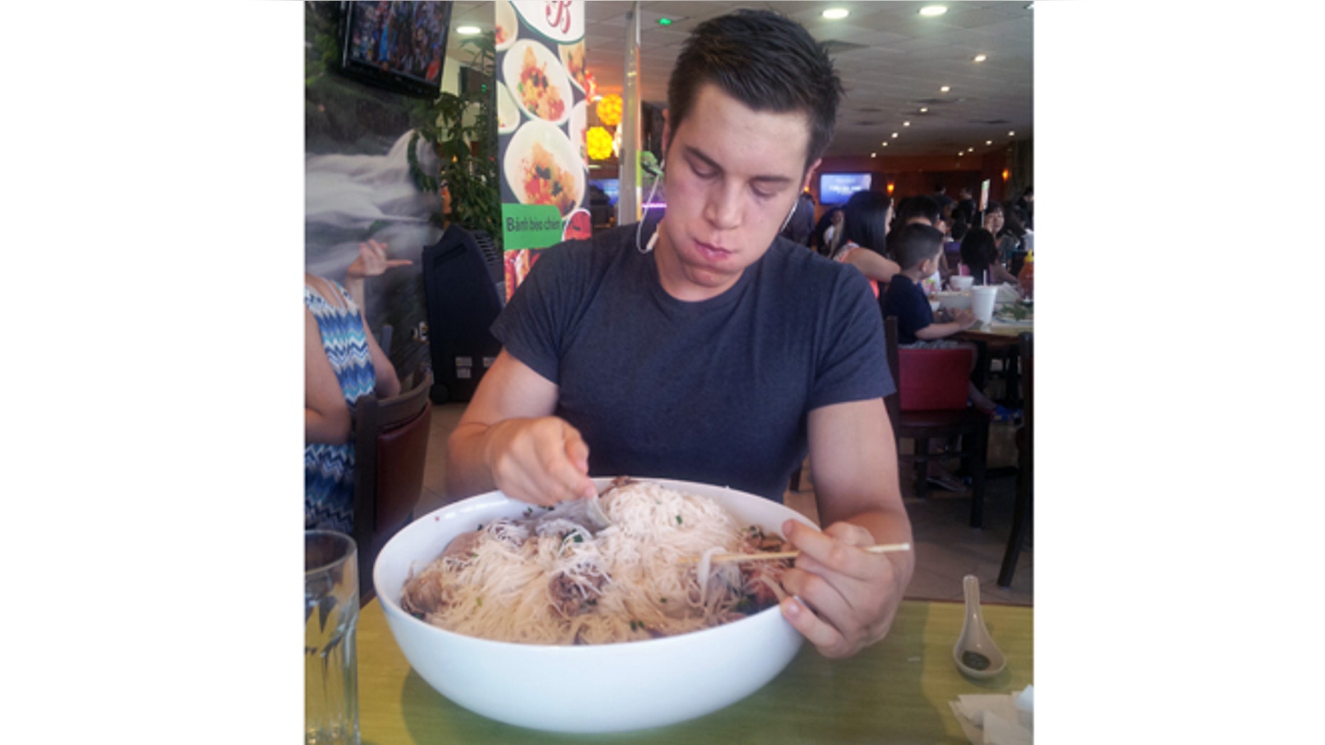 In this undated photo provided by Eric Dahl, Dahl, a University of Wisconsin computer engineering student with a nickname of "Silo," fills up on a 13-pound bowl of Vietnamese noodles known as pho.