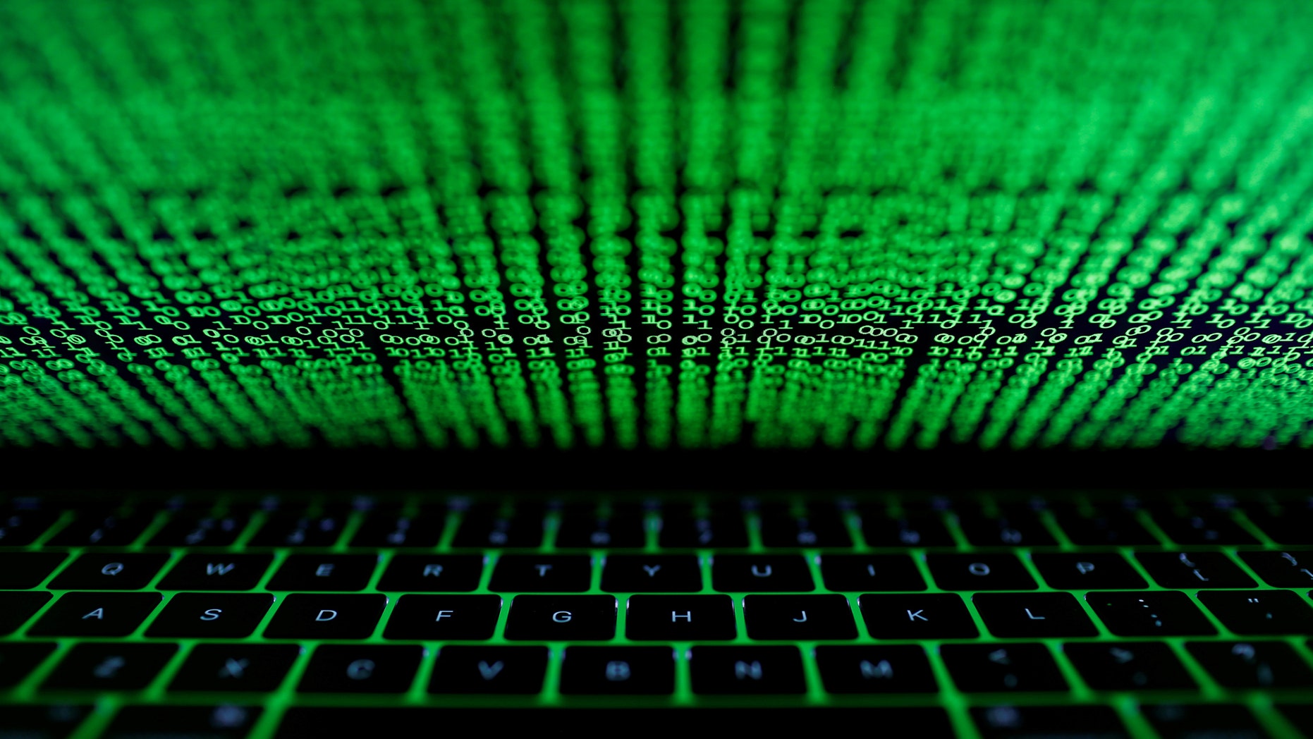 A computer keyboard lit by a displayed cyber code is seen in this illustration picture taken on March 1, 2017. (REUTERS/Kacper Pempel/Illustration)