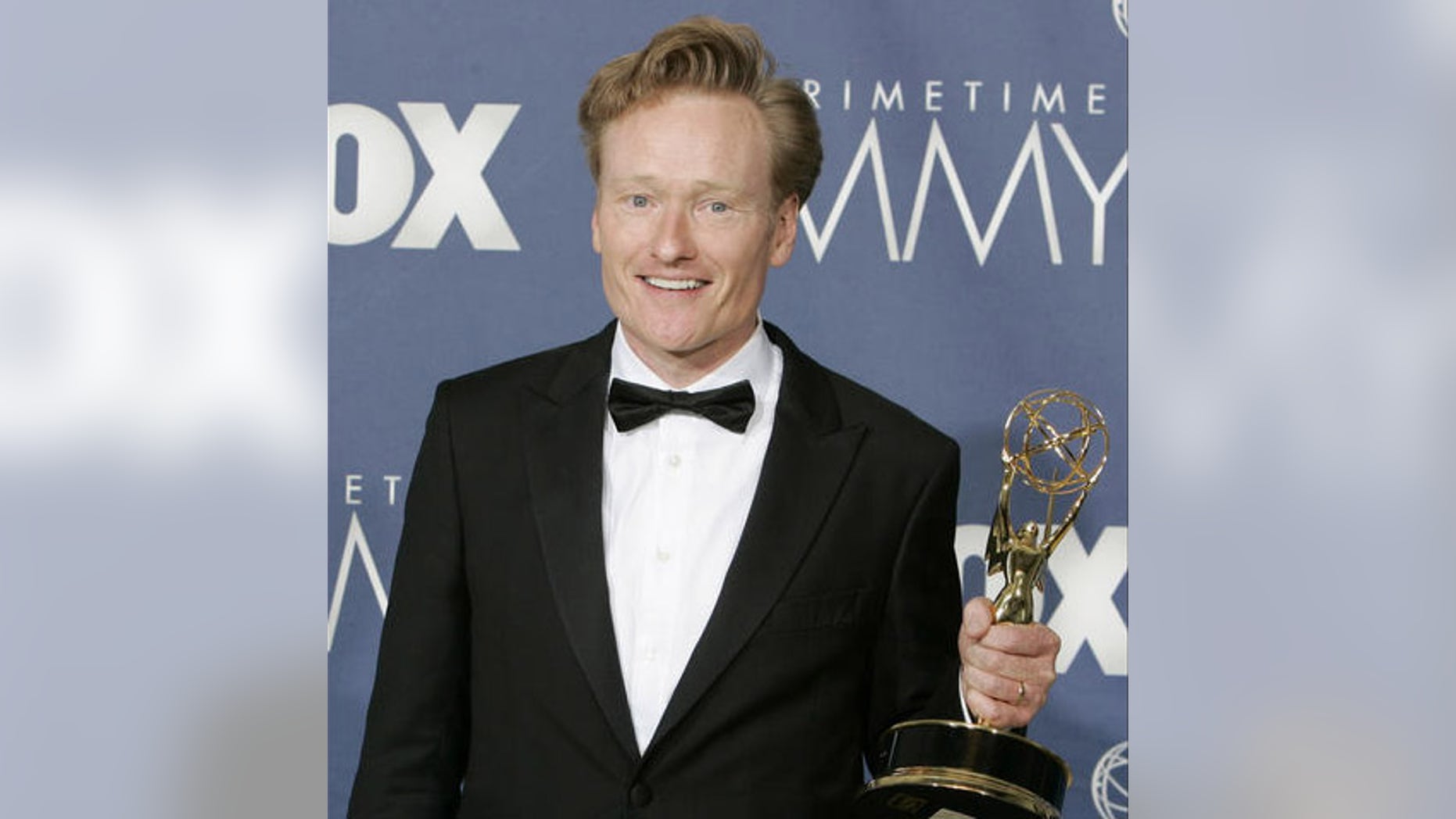 Conan O'Brien holds the awards for outstanding writing for a variety, music or comedy program for "Late Night with Conan O'Brien" the 59th Primetime Emmy Awards Sunday, Sept. 16, 2007, in Los Angeles. (AP Photo/Chris Carlson)
