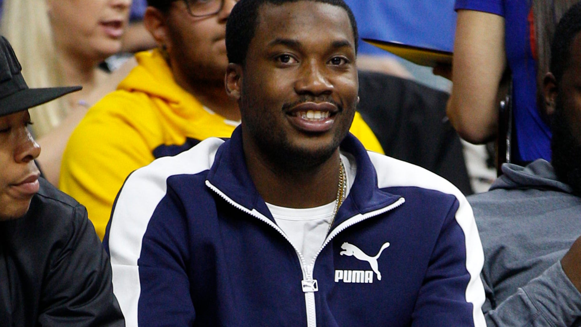 In this Wednesday, Feb. 3, 2016, photo, rapper Meek Mill looks on during the second half of an NBA basketball game between the Atlanta Hawks and the Philadelphia 76ers in Philadelphia.