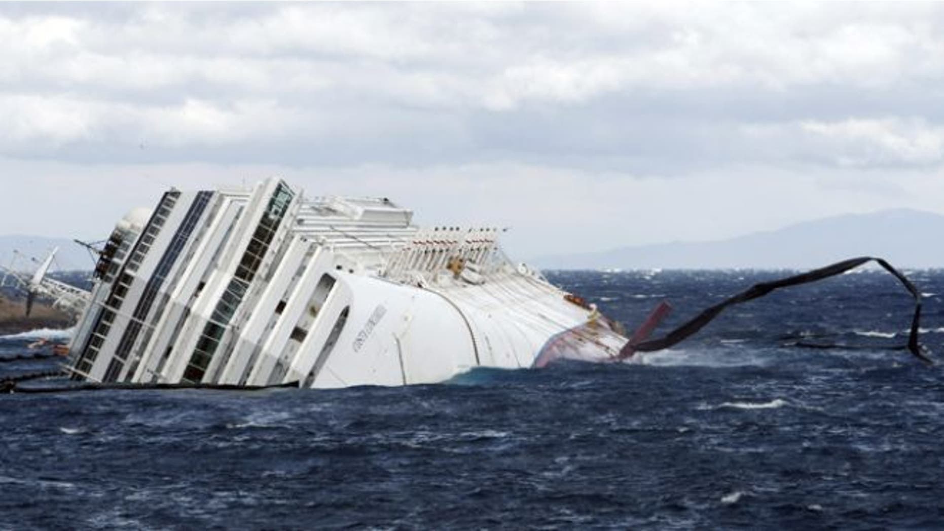 Feb. 1, 2012: Anti oil floating barriers are pushed by strong winds around the grounded cruise ship Costa Concordia off the Tuscan island of Giglio, Italy.