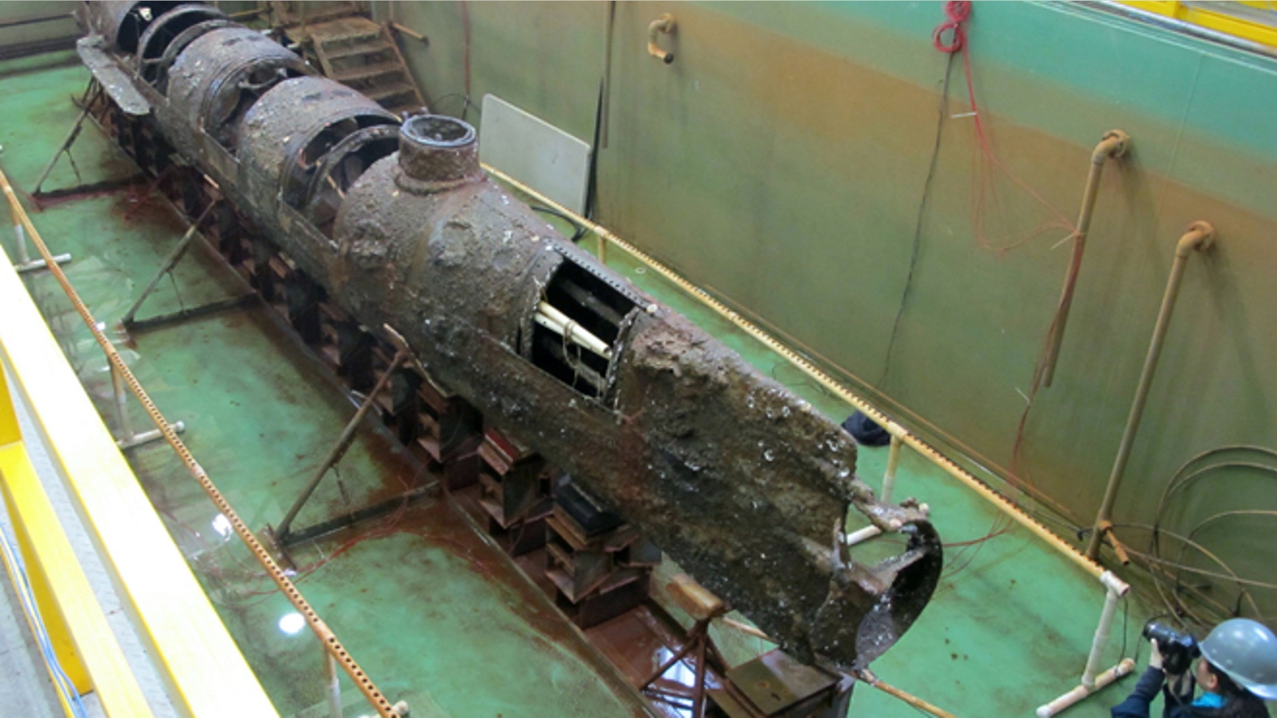 Jan. 12, 2012: The Confederate submarine H.L. Hunley sits in a conservation tank after a steel truss that had surrounded it was removed in this file photo taken at a conservation lab in North Charleston, S.C. Scientists say a pole on the front of the Confederate submarine H.L. Hunley designed to plant explosives on enemy ships may hold a key clue to its sinking during the Civil War.
