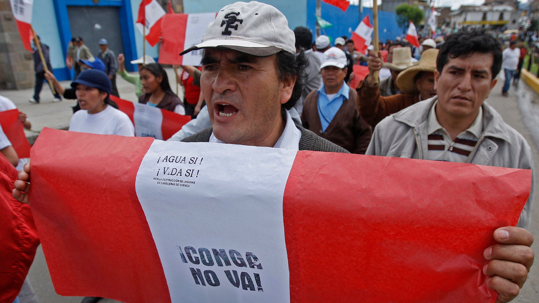 A demonstrator shouts slogans while marching in a protest against the Conga gold and silver mining project, in Cajamarca, Peru, Monday Jan. 2, 2012. Although the government says the project will generate thousands of jobs, protesters worry that the $4.8 billion Conga gold mine could taint and diminish their water supply. (AP Photo/Karel Navarro)