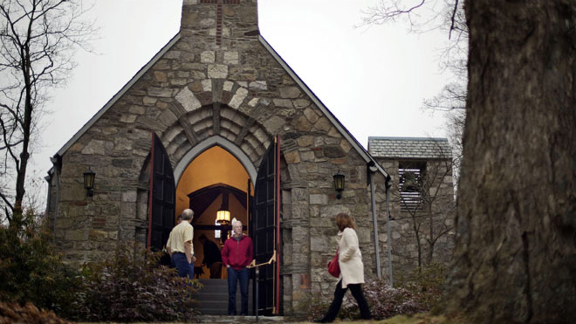 Dec. 16, 2012: A churchgoer enters a service at at St John's Episcopal Church, in Newtown, Conn.
