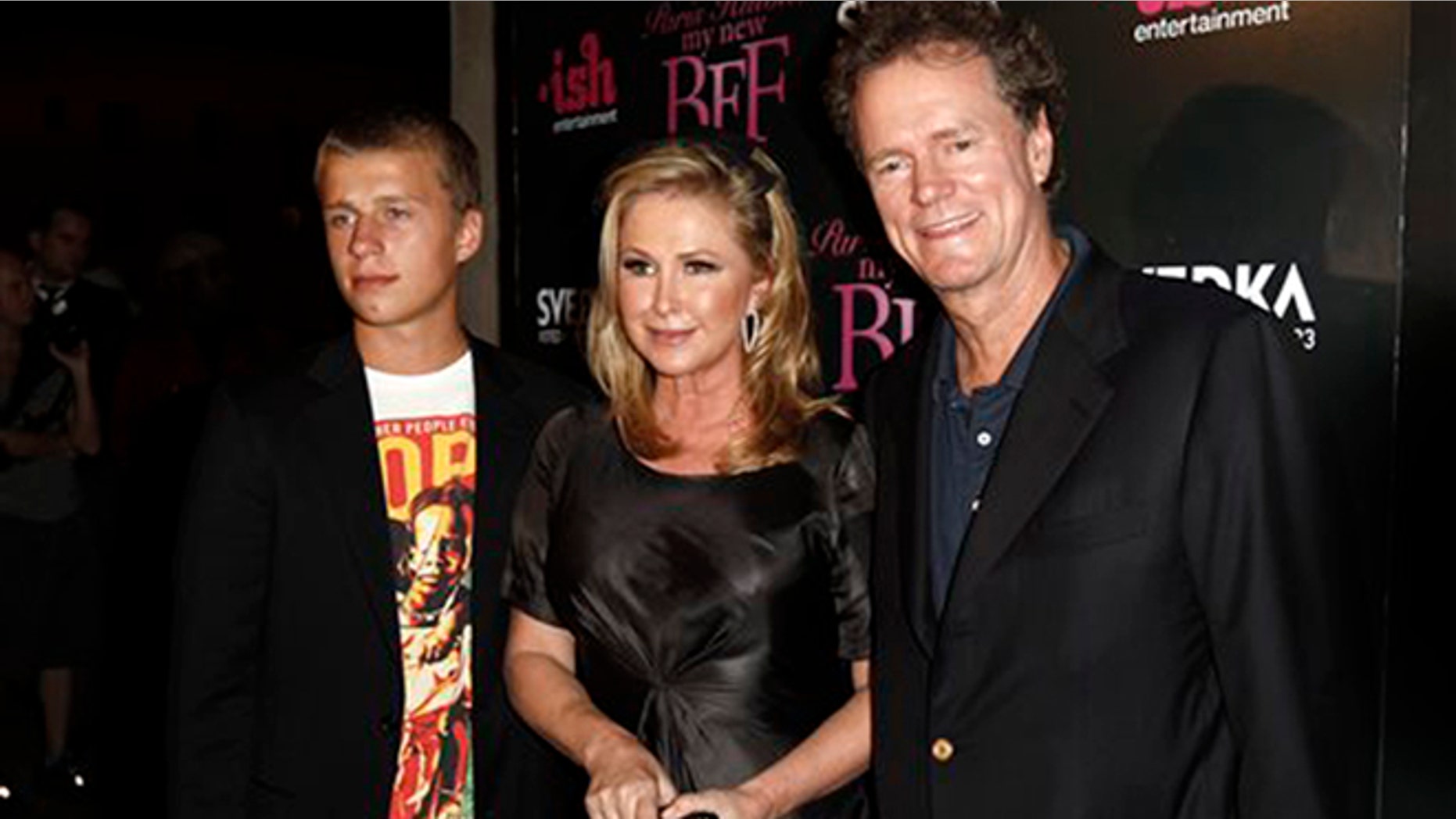 In this Sept. 30, 2008 file photo, Conrad Hilton, left, Kathy Hilton, center, and Rick Hilton arrive at the launch party of new MTV series "Paris Hilton's My New BFF" in Los Angeles. Paris Hilton's youngest brother, Conrad, has been sentenced to community service and a $5,000 fine for disrupting a flight from London to Los Angeles in 2014.