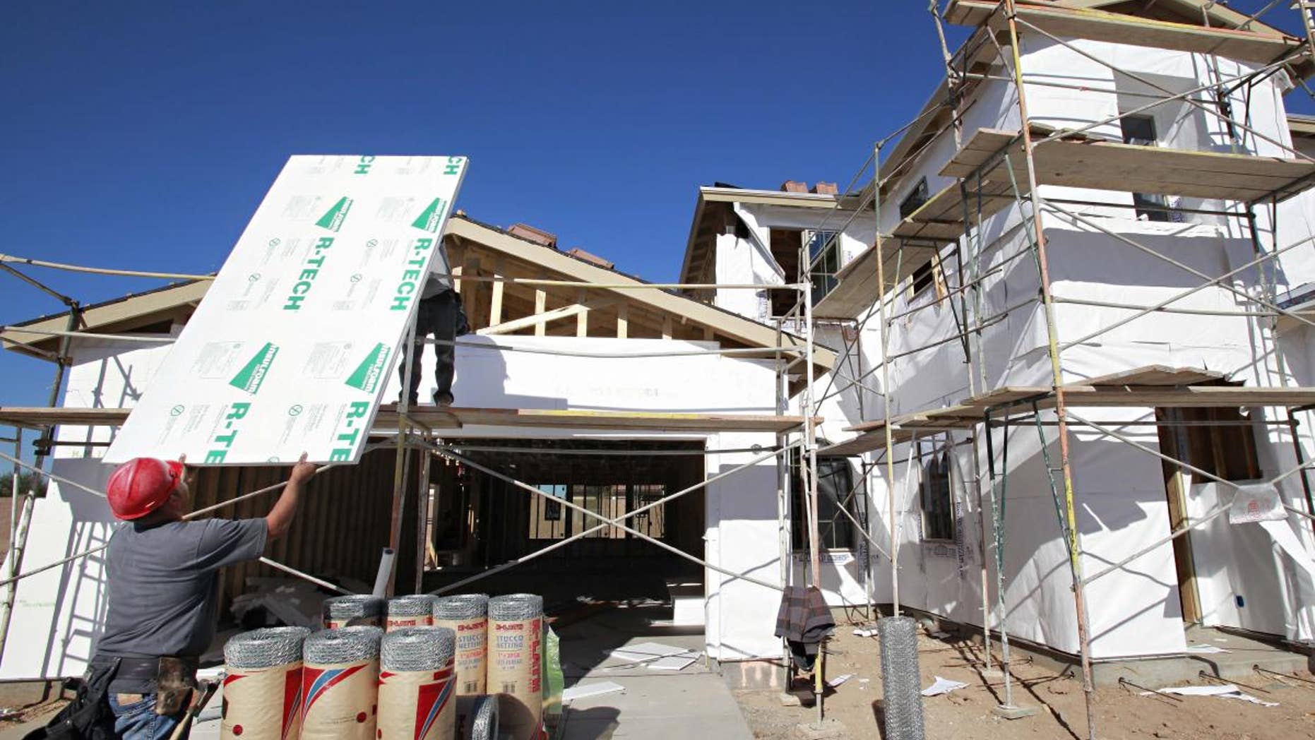Construction workers build a house Tuesday, Nov. 30, 2010 in Gilbert, Ariz. (AP Photo/Matt York)