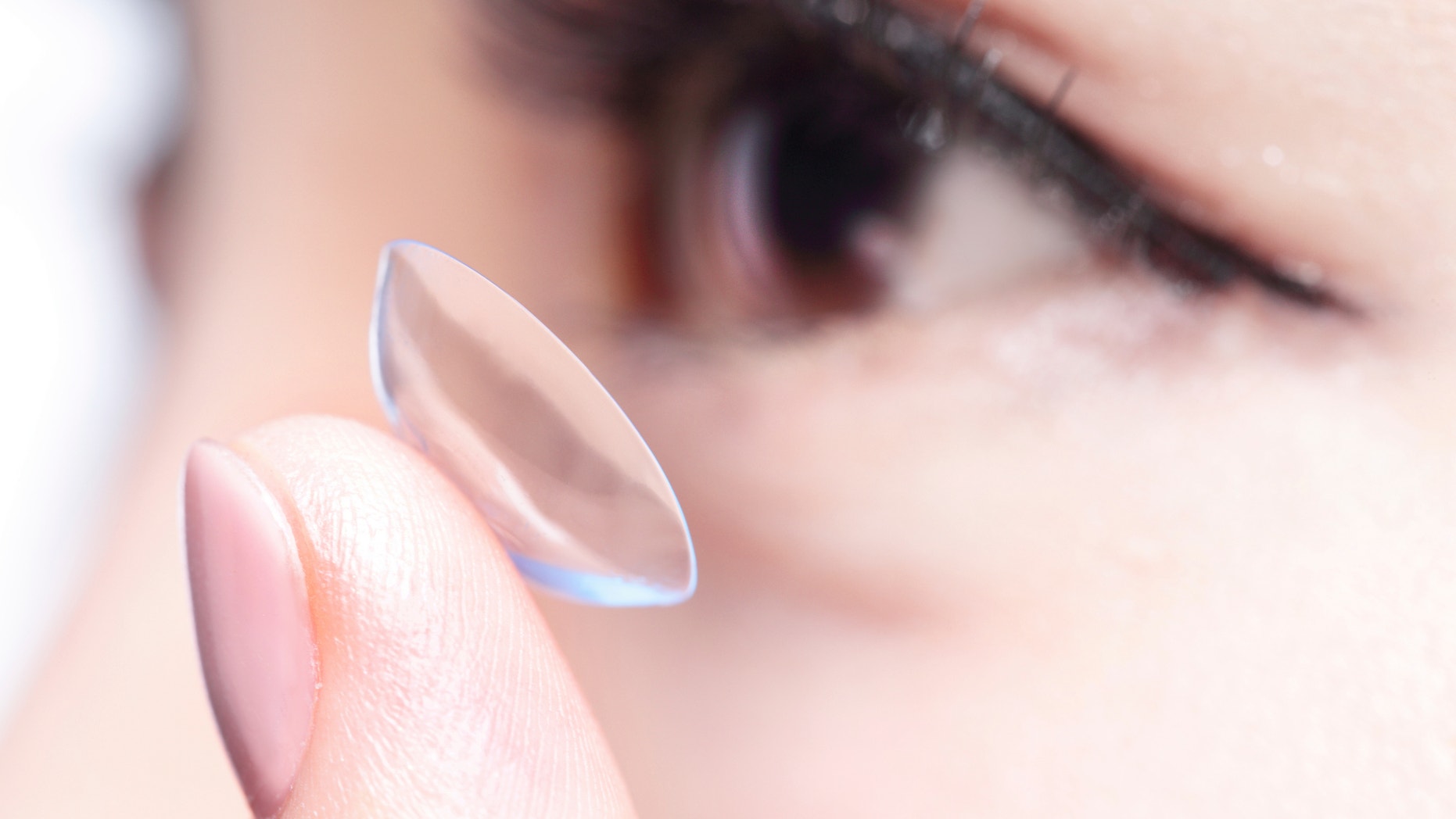 Beautiful woman human eye and contact lens