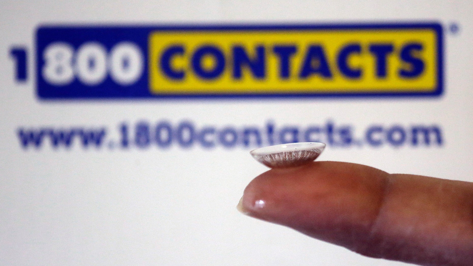 In this file photo, a contact lens is displayed in front of a 1-800-Contacts shipping box in Salt Lake City.